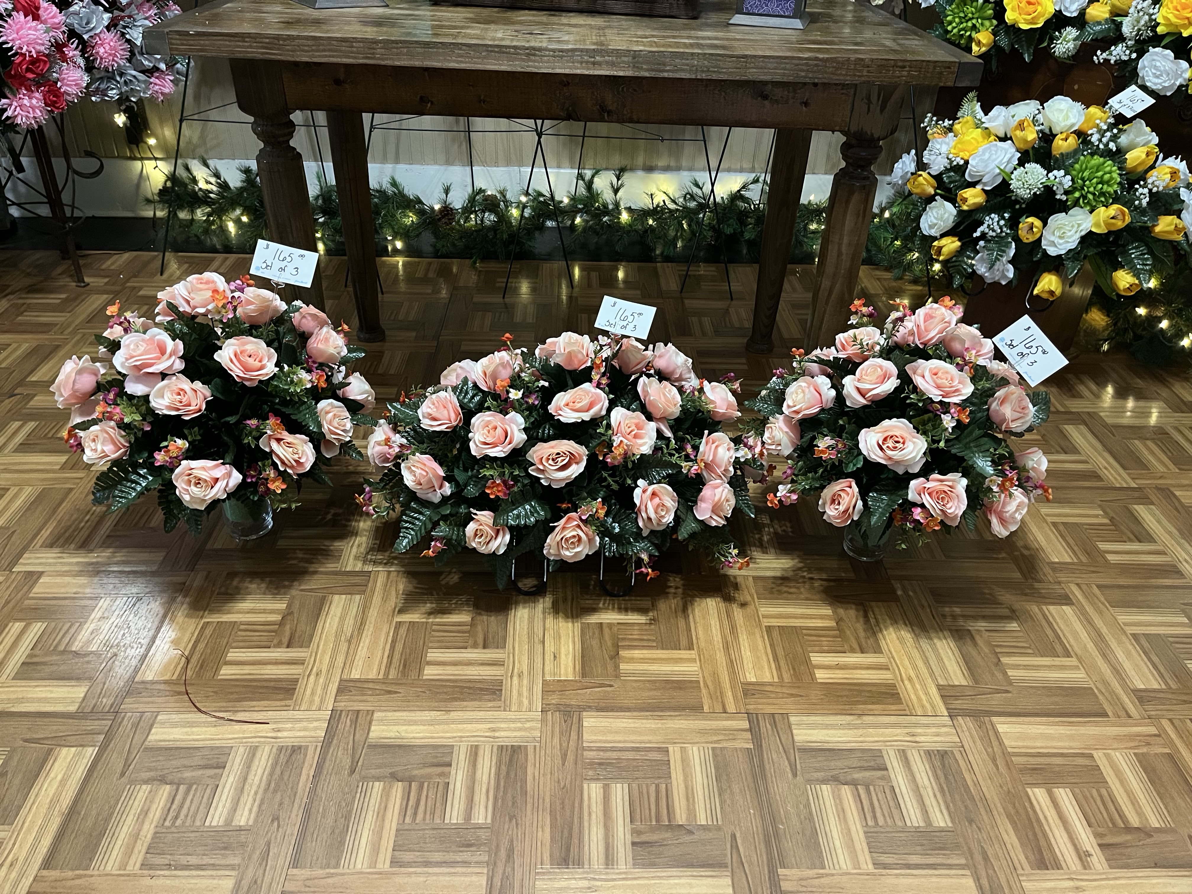 Large Pink Silk Cemetery Saddle &amp; 2 Vases Combo - Beautiful pink colors cover this saddle and  vases as a celebration of the memory of your loved one. Created in bold colors in high quality silk flowers for a lasting gift to be left at the gravesite. Delivered on a stand for services
