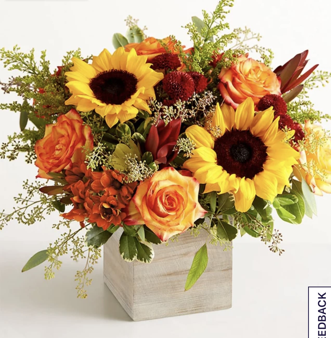 Harvest glow bouquet  - About Harvest Glow™ Bouquet EXCLUSIVE The color and charm of an autumn country harvest inspired our farmhouse-style bouquet. A relaxed gathering of blooms in vibrant shades of red, orange, and yellow creates the perfect complement to our rustic, gray-washed wooden cube, which adds coziness to any décor.
