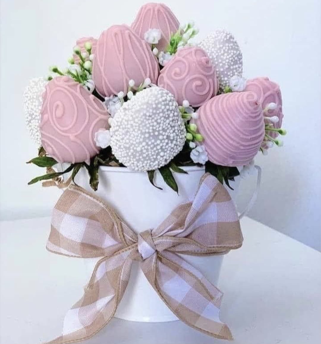Blush Pearl Temptation - A vision in soft pink and ivory. This exquisite arrangement features hand-dipped strawberries in blush pink and creamy white chocolate, elegantly accented with shimmering pearl details. Nestled inside a stylish souvenir mug and finished with a coordinated designer bow, it is a gift designed to be cherished. Perfect for the one who loves the finer, more delicate details of life.