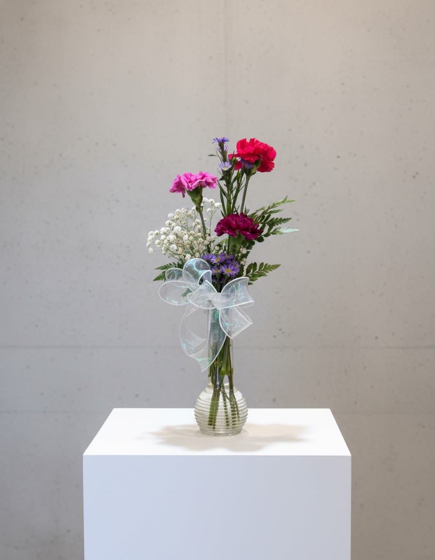 Original Love - Designers Choice  - Sweet, cheerful, and full of Valentine’s charm, this Designer’s Choice arrangement features three fresh carnations designed in a festive mix of Valentine’s Day colors. Accented with complementary seasonal filler and greenery, each arrangement is thoughtfully crafted to highlight texture, color, and balance. Compact and charming, it’s the perfect little pick-me-up for desks, side tables, or heartfelt surprises. Every design is unique, making this a fun and thoughtful way to share love and color this Valentine’s Day.  *CAN NOTE COLOR PREFERENCES IN NOTES - SUBJECT TO AVAILABILITY 