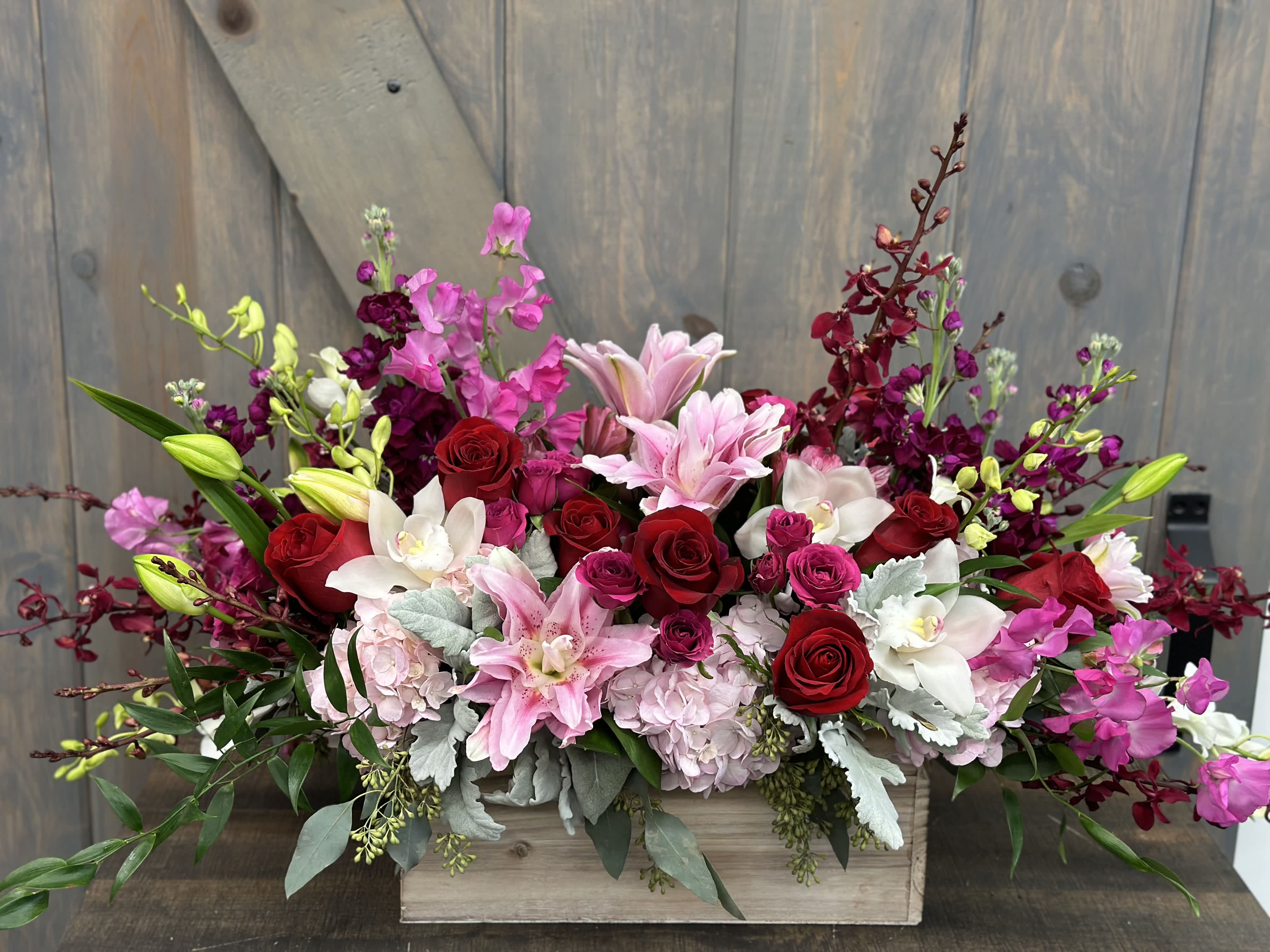 Love in Bloom Box - This elegant and lush arrangement exudes love. Included in this luxurious design are Roses, Spray Roses, Hydrangea, Rose Lily's, Stock, Azema Orchids, Dendrobium Orchids, Sweet Pea's, and Cymbidium orchids.