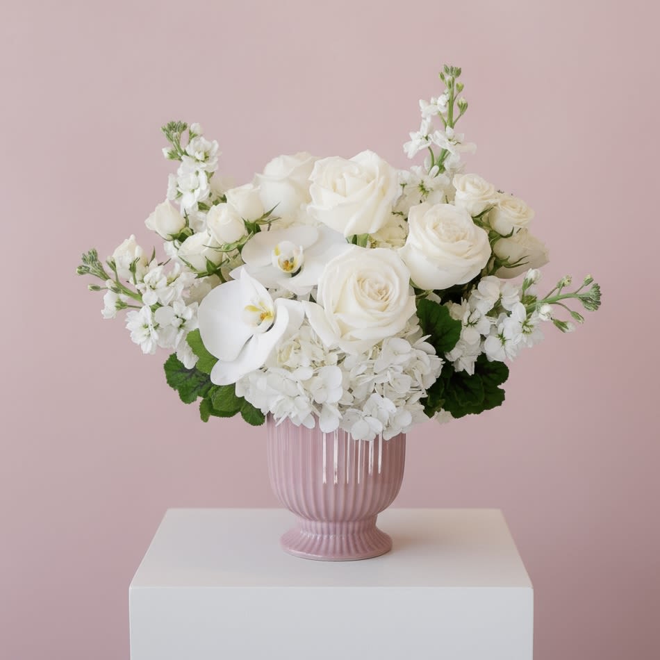 All My Love - All My Love is a timeless arrangement designed in a soft, romantic palette of white and ivory. Featuring premium white roses, delicate spray roses, lush hydrangea, graceful orchid blooms, and fragrant stock, this composition feels serene, elegant, and beautifully refined. Styled in a blush-toned ceramic pedestal vase, it’s a sophisticated expression of love—perfect for Valentine’s Day, anniversaries, or moments that call for understated luxury.  Handcrafted by our floral designers in Brentwood, this arrangement is available for flower delivery throughout West Los Angeles (including Brentwood, Santa Monica, Beverly Hills, Bel Air, Westwood, Pacific Palisades, Culver City, and surrounding Los Angeles neighborhoods)