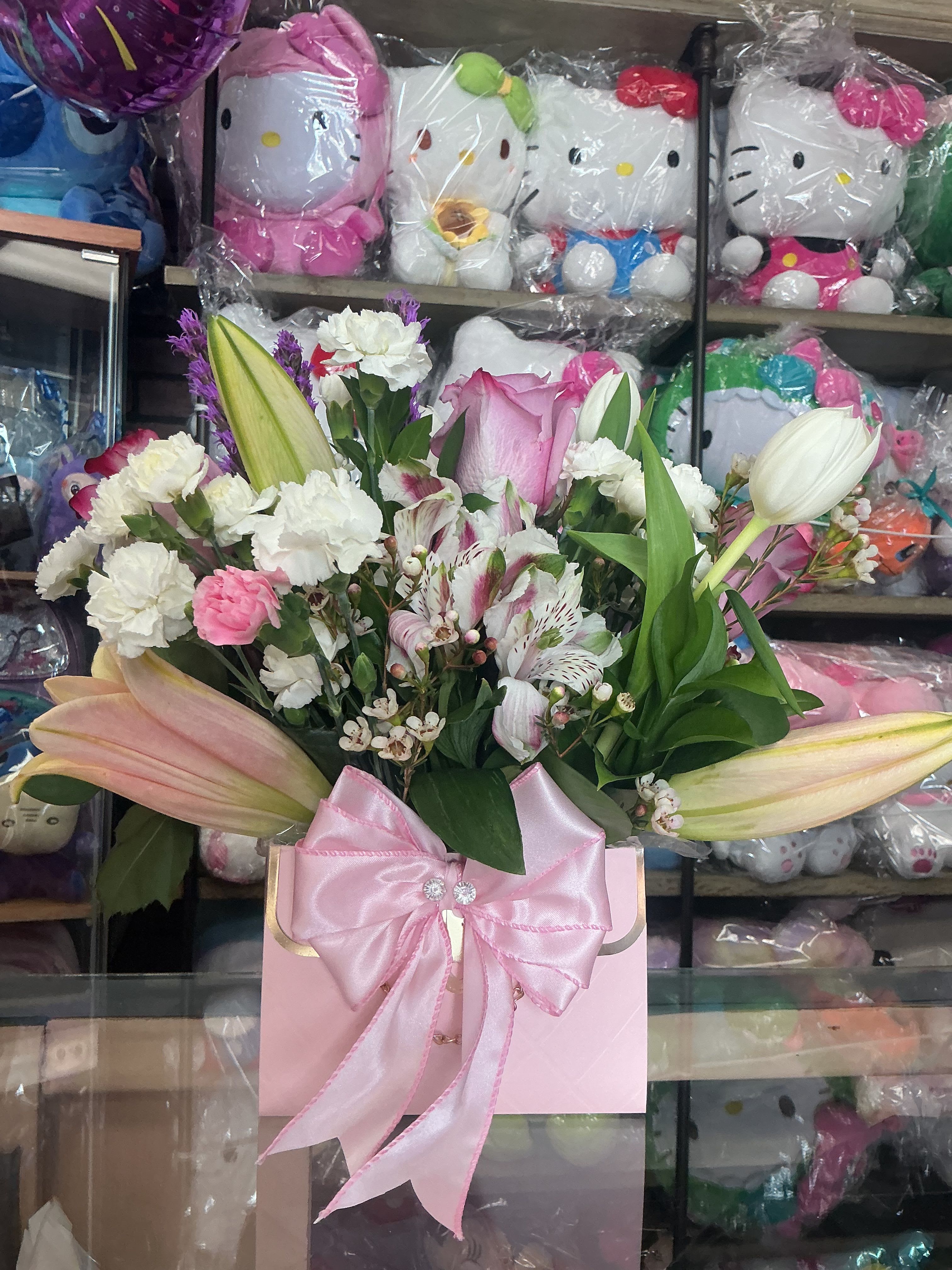 Pinky pink  - This elegant pink handbag with all of mix flowers is made of cute roses , tulips ,carnation,wax and much more ready to impress 