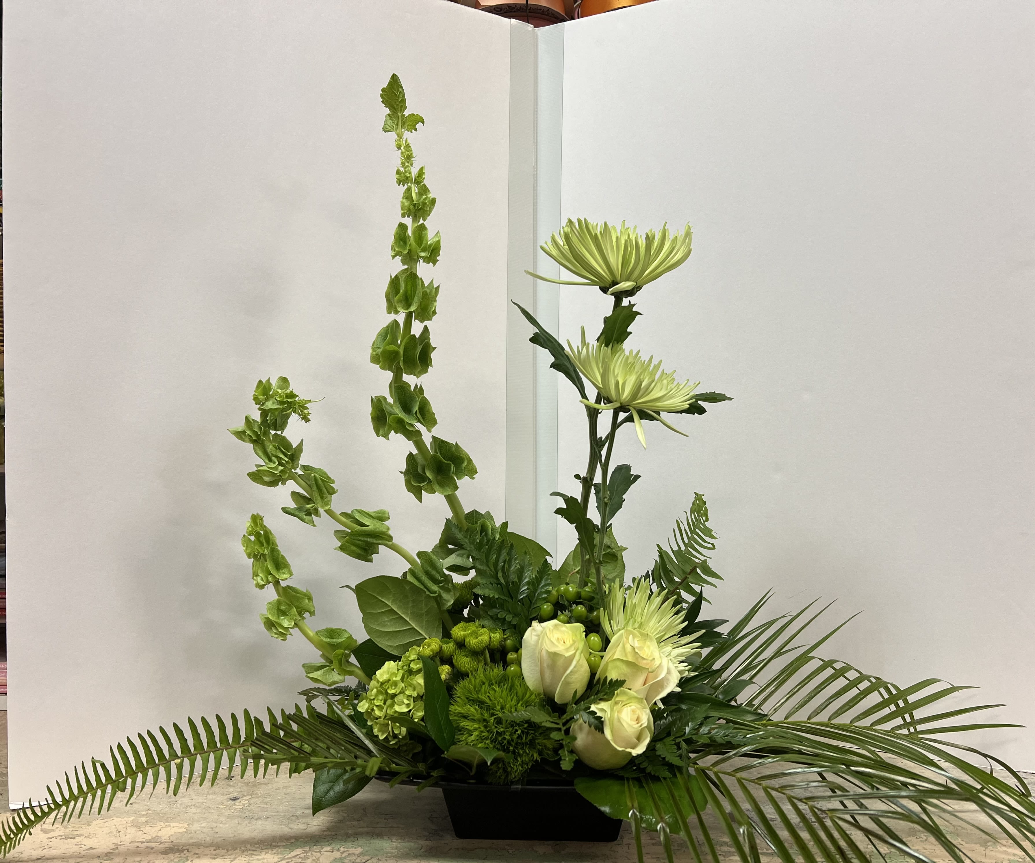 WS-0621 - Contempory feel with fuji mums, Bells of Ireland, hypericum, hydrangea, green button poms,  green ball dianthus, sword fern, robolini