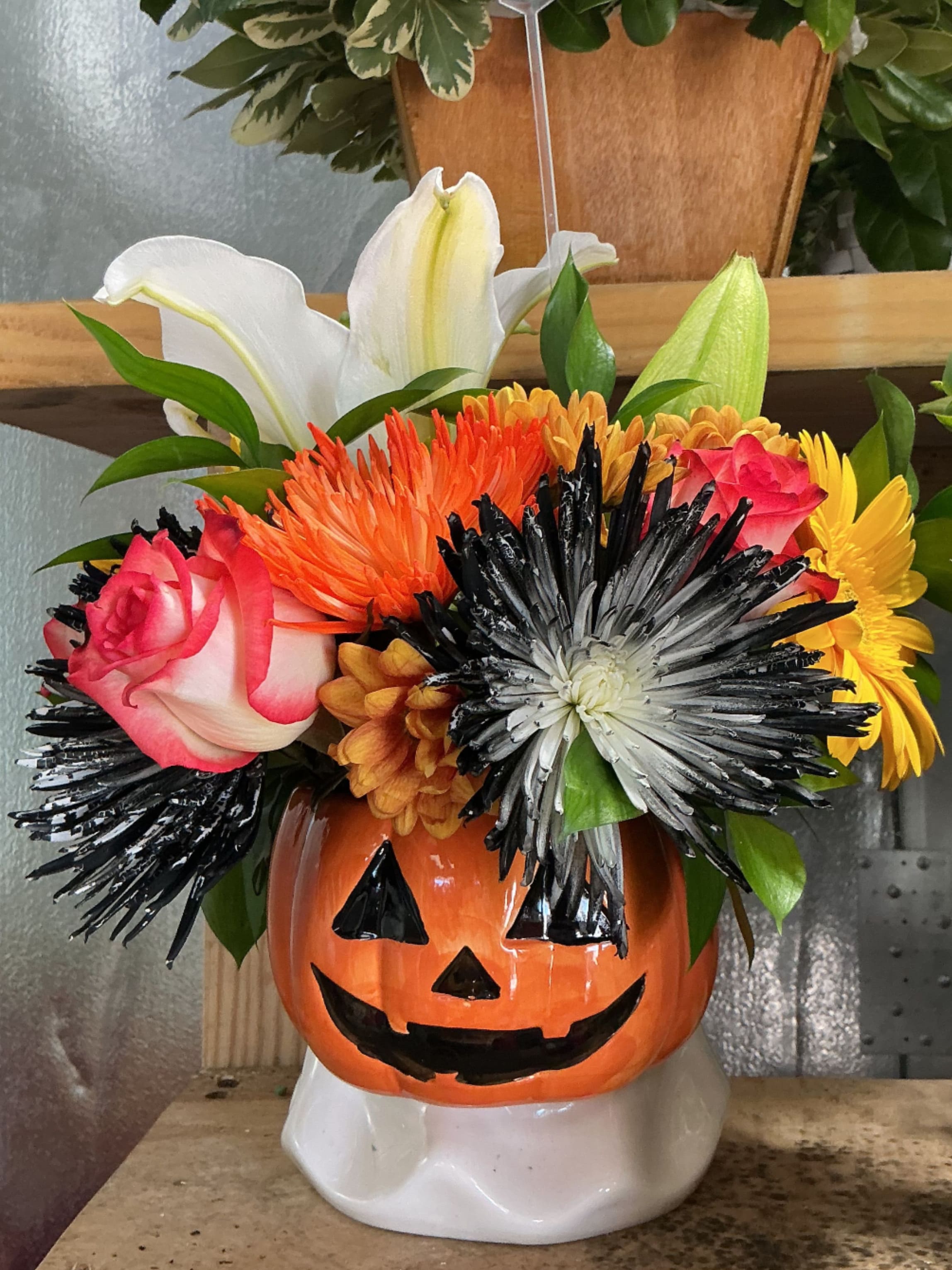 Halloween  - This beautiful pumpkin is made of orange roses ,withe lillies ,black spiders and brown daisys 