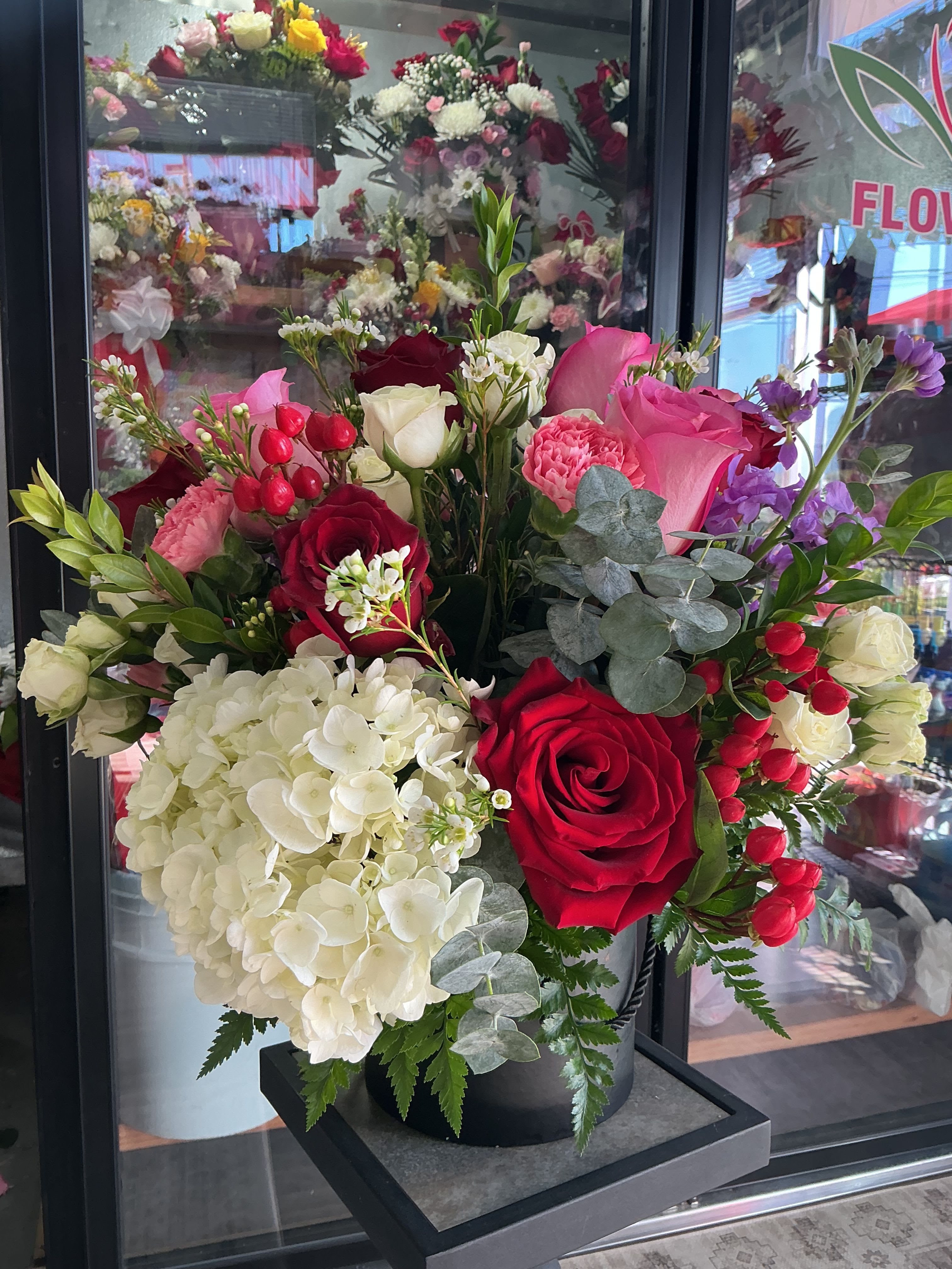 Pink and red love  - This cute arrangement is perfect for any occasion,made of pink and red roses ,white roses ,greens,gardenia and much more 
