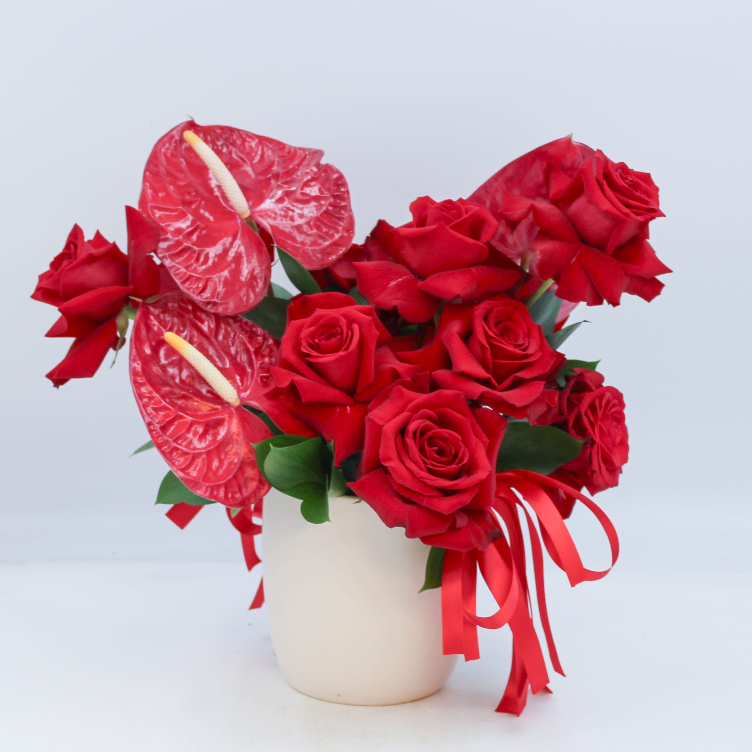 Milan - Milan is a limited edition design for our Valentine’s en vogue collection and features amazing Red Anthurium tropical flowers and reflexed premium Red Roses in an ivory ceramic pot adorned with red satin ribbon. 