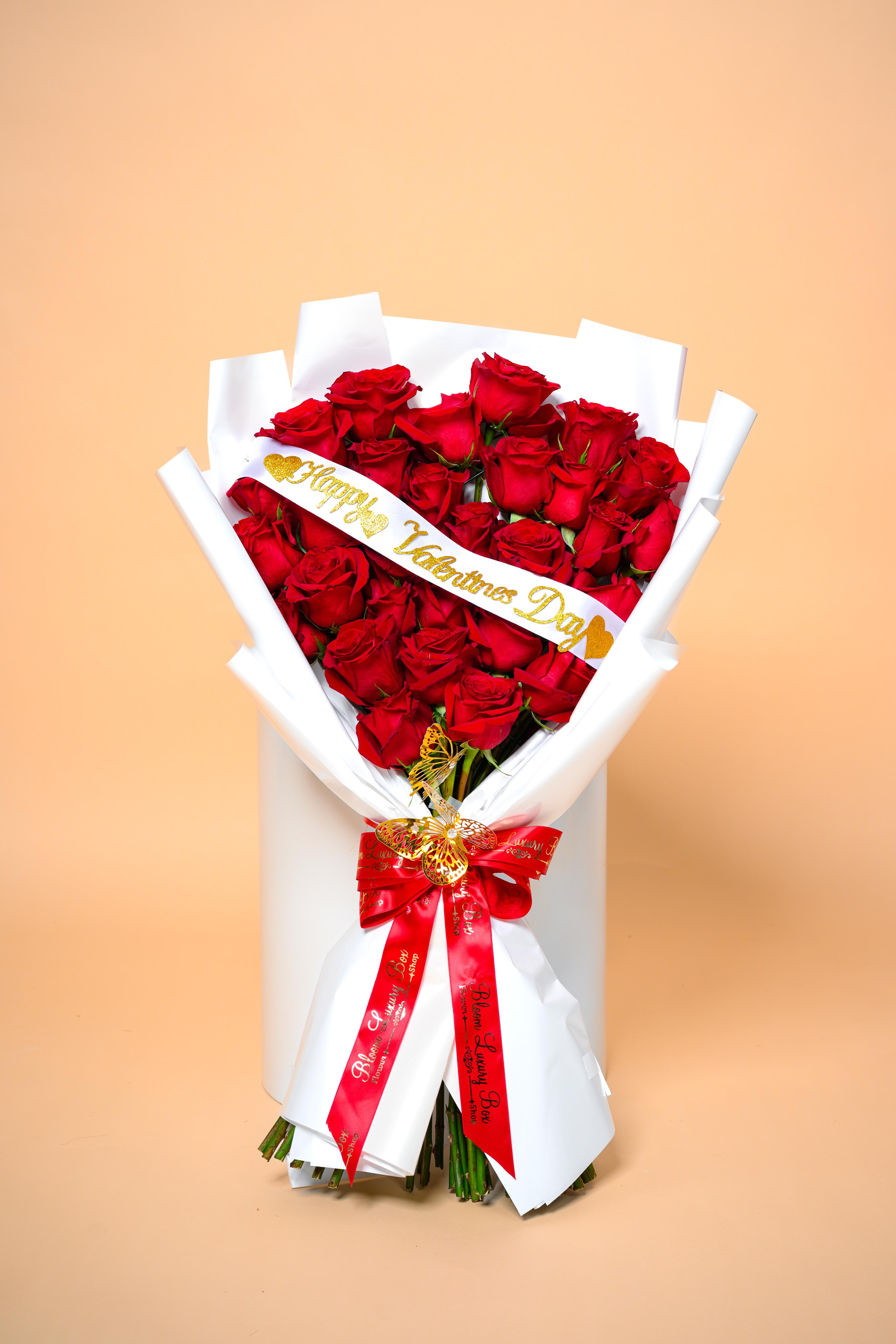 Valentine’s Embrace - This stunning bouquet features radiant red roses arranged to create a bold and romantic statement. Finished with a signature ribbon and elegant wrapping, Valentine’s Embrace delivers love in its purest and most sophisticated form.