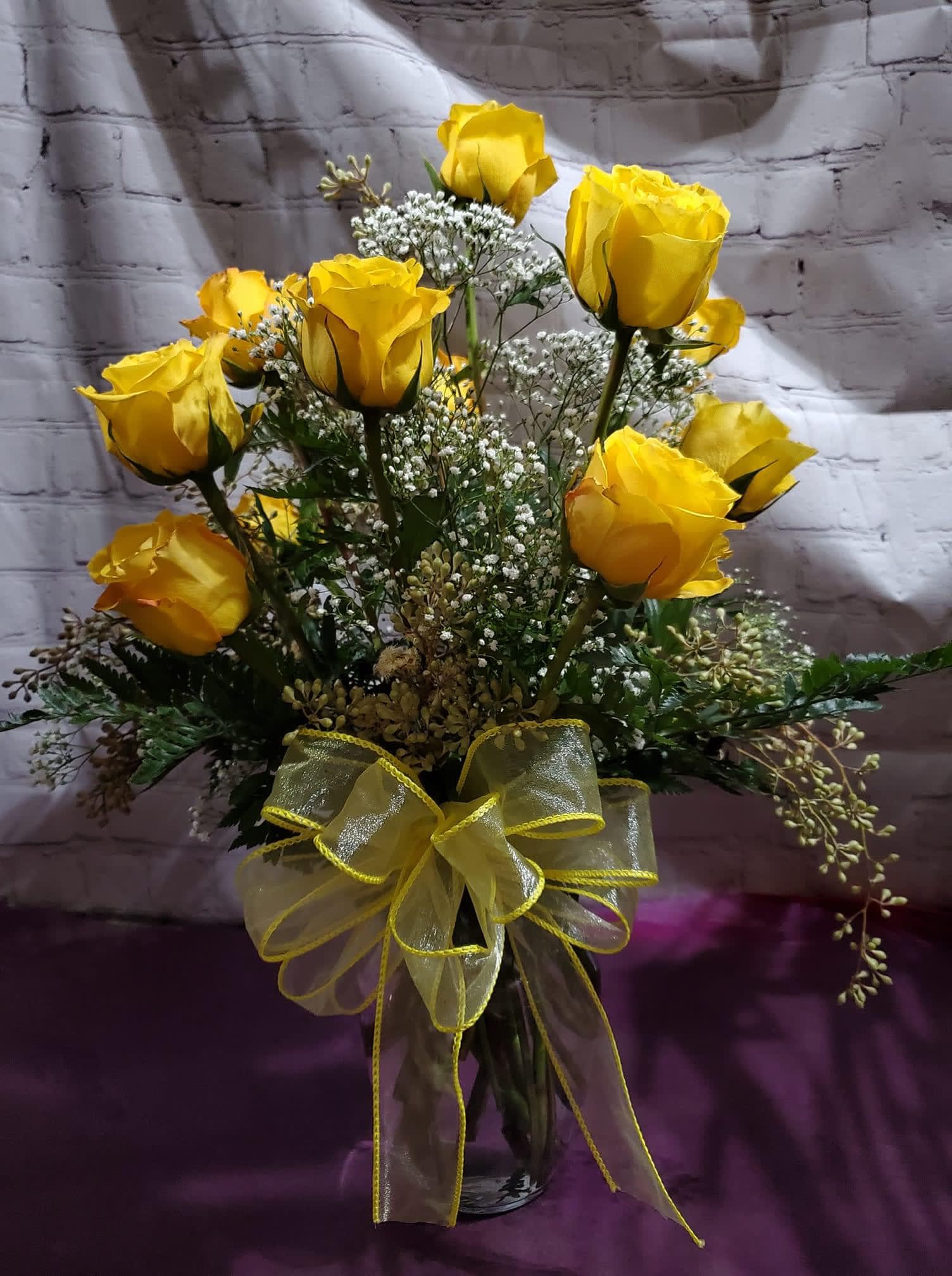Dozen Yellow Roses  - One dozen yellow roses arranged with babies breathe and greenery in a vase 