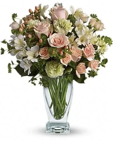 Anything for You - You'd do anything for her, so let her know how you feel by sending this generous and gorgeous arrangement. Who could ask for anything more? Beautiful peach roses and spray roses, white alstroemeria, brilliant green carnations, peach hypericum and fresh garden greens are perfectly hand-arranged in a feminine Couture Vase. 
