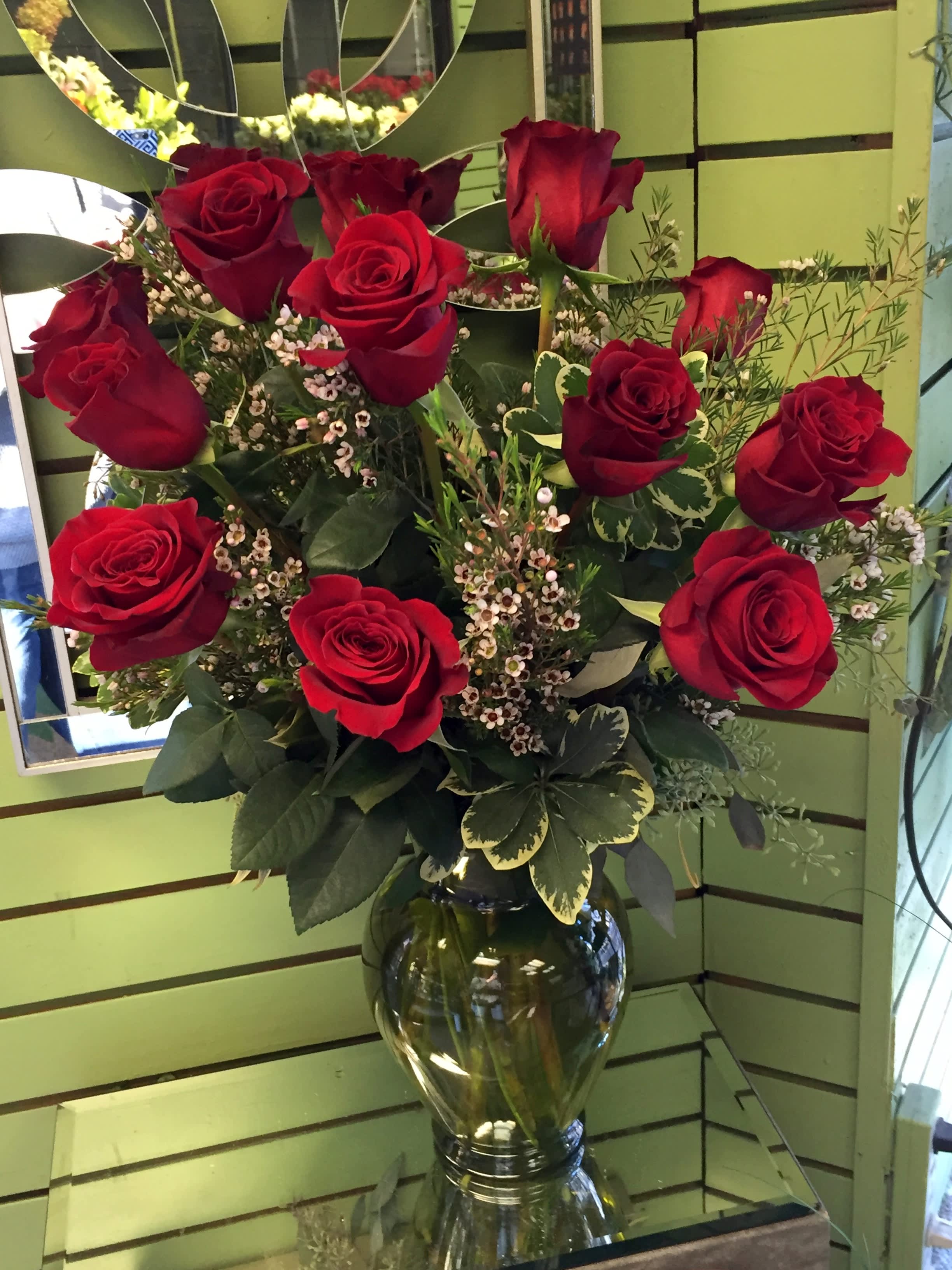 Classic Red Roses - 12 red roses arranged in a fluted vase - mixed foliage or floral filler - the choice is yours....