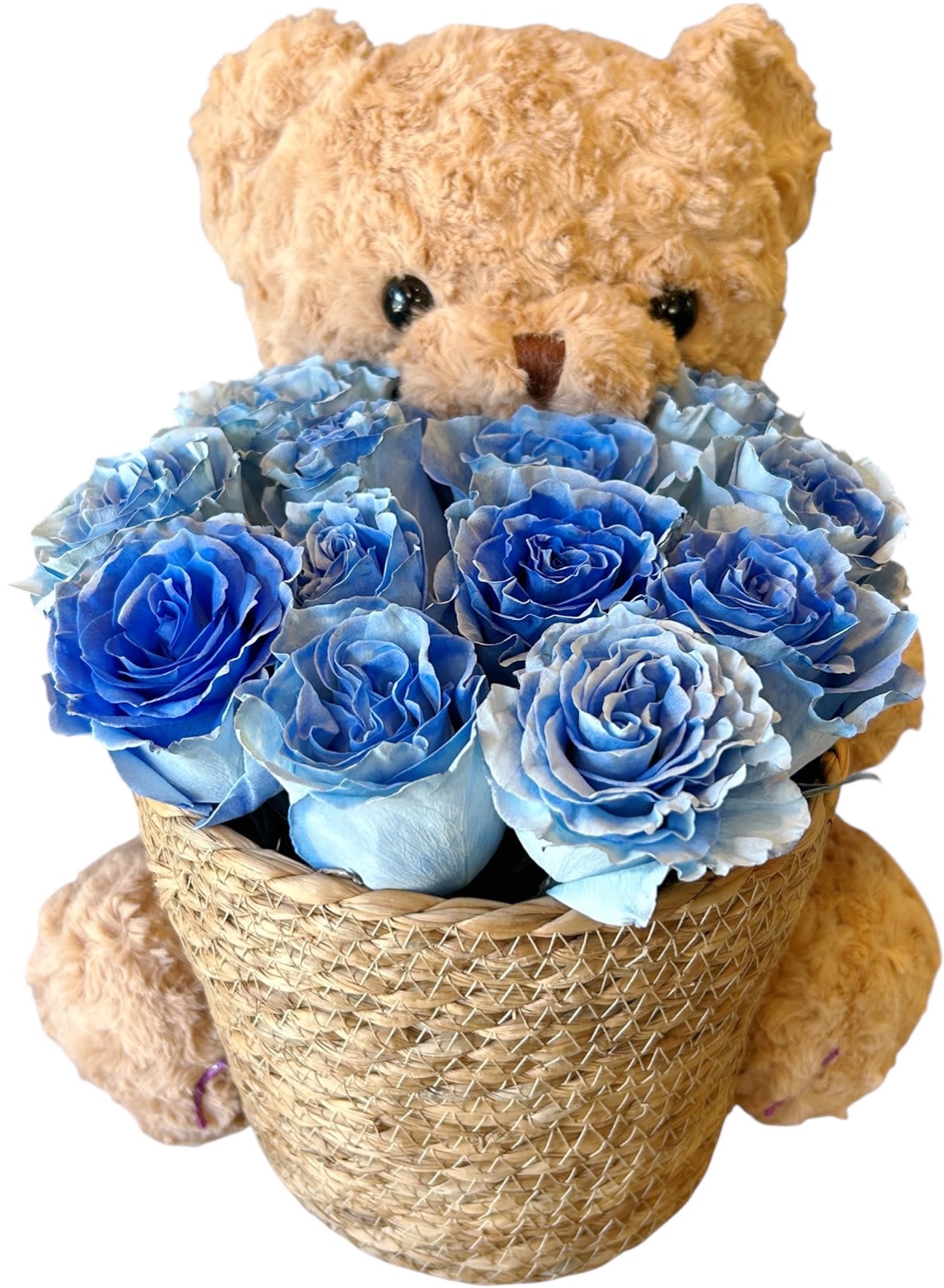 Blue Purple Teddy Bear - A sweet teddy bear cuddles a basket of delicate blue roses, as refreshing as the ocean breeze and as pure as the sky. Blue roses symbolize miracles and romance, while the teddy bear adds a touch of warmth and comfort.  Whether it’s for a loved one, a dear friend, or simply a little treat for yourself, Blue Bear Bliss is the perfect way to bring joy and sweetness into any moment.