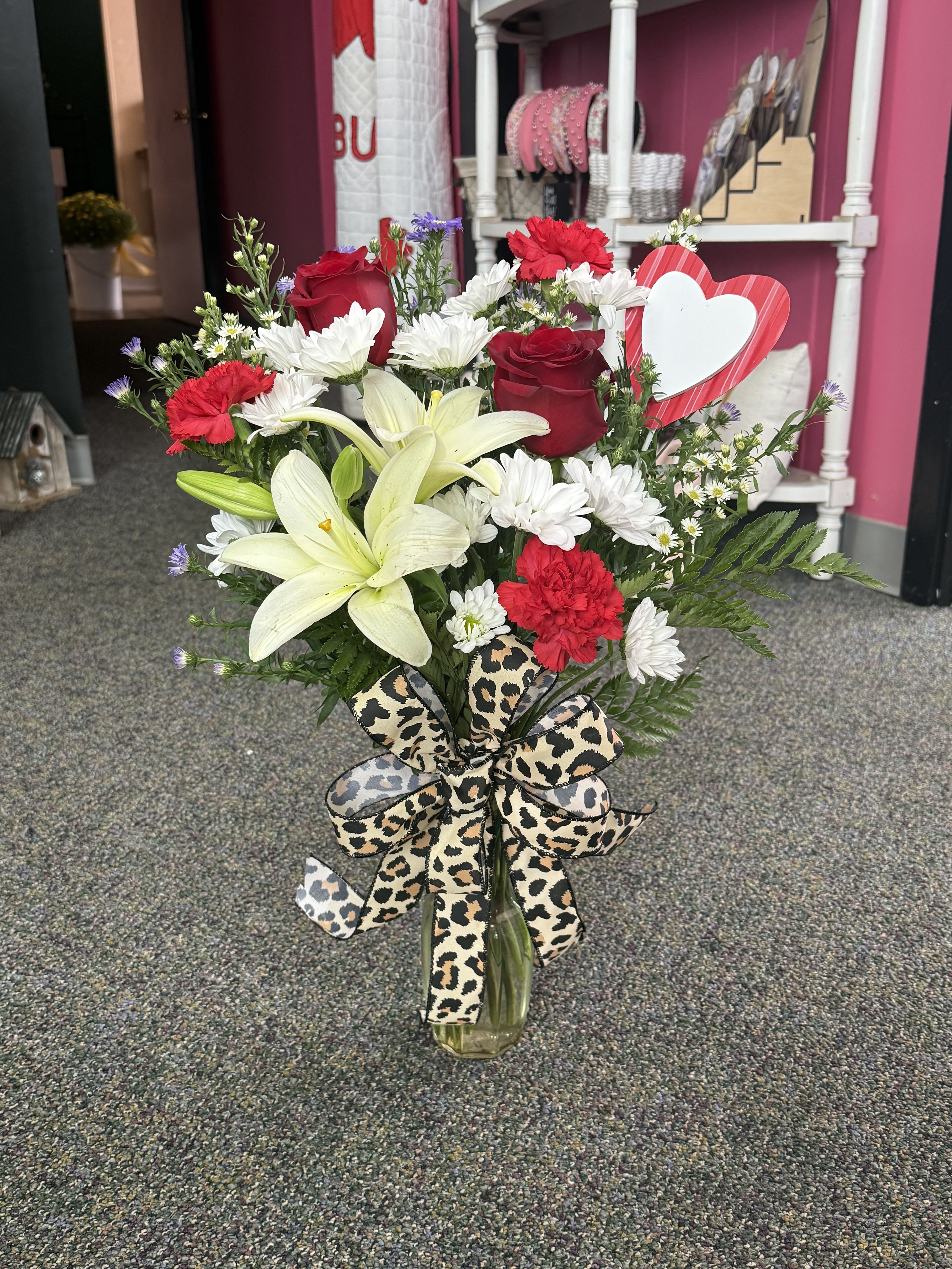 Valentine's Super Bud Vase - A charming mix of fresh Valentine blooms arranged in a clear glass bud vase. This sweet design is perfect for desks, nightstands, or a little “just because” surprise. Small in size but full of love—perfect for spreading smiles this Valentine’s Day.