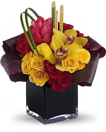 Island Dreams - Island dreams can come true no matter where you are if you're lucky enough to receive this delightful bouquet. It beautifully combines tropical flowers with greens and hand-delivers them in a dramatic black cube vase. Yellow cymbidium orchids, red ginger, red and yellow spray roses, leaves and grass are perfectly tucked into a modern cube vase. Send a dream come true! 