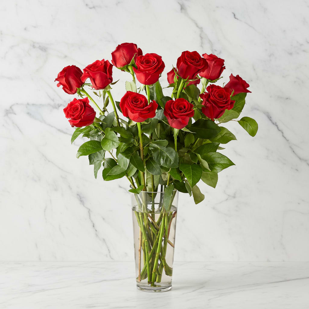 12 Long Stem Red Roses - You can never go wrong with a bouquet of hand delivered long stem red roses arranged by our expert designers. This timeless red bouquet will make a statement for your special someone. Red flowers are an elegant, iconic and romantic gift for anyone close to your heart. Each rose is handcrafted and hand delivered to say I love you.   Please Note: The bouquet pictured reflects our original design for this product. While we always try to follow the color palette, we may replace stems to deliver the freshest bouquet possible, and we may sometimes need to use a different vase. 