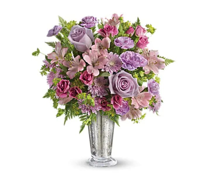 Sheer Delight Bouquet - The essence of femininity. Delight her with flirty-fun lavender and pink blooms presented in a gorgeous Mercury Glass julep vase. It's a gift that will sparkle in her memory forever. Includes lavender roses, pink alstroemeria, miniature lavender carnations and lavender chrysanthemums, accented with fresh bupleurum and leatherleaf fern. Delivered in a Mercury Glass large julep vase.   Orientation : All-Around  All prices in USD ($)  Due to seasonal price increase on flowers, our prices will reflect an increase for this holiday on certain delivery dates.  Standard  TEV29-1A  Deluxe  TEV29-1B  Premium  TEV29-1C