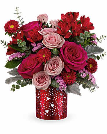 Heartstruck Bouquet - Striking and romantic, the Heartstruck Bouquet steals the spotlight with hot pink and red blooms arranged in a red metal lantern featuring heart and dot cutouts-an unforgettable Valentine's Day surprise they'll treasure. Bouquet includes hot pink roses, pink spray roses, red alstroemeria, red matsumoto asters, pink sinuata statice, dusty miller, and spiral eucalyptus, presented in the I Heart You Lantern, a red metal lantern with heart and dot cutouts. Approximately 13 1/2" W x 14" H