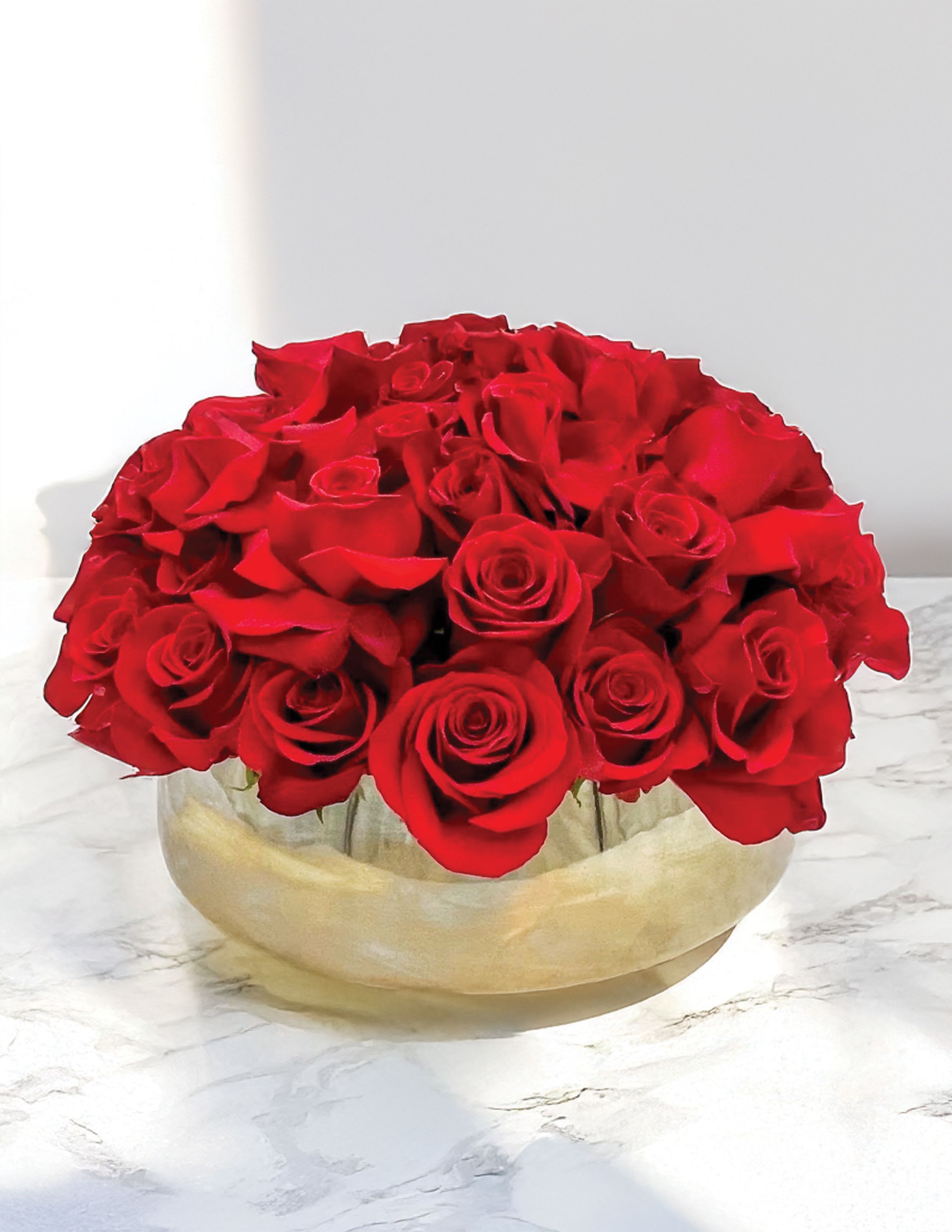Manhattan - Manhattan is a classic modern luxury; Fifty premium Red Roses in a large gold keepsake ceramic vase. This vase is perfect to fill with Orchids or any other plants in the future! We also have this vase in black and white, if you prefer one of those colors please indicate that in notes. Design is shown in its Standard size. 