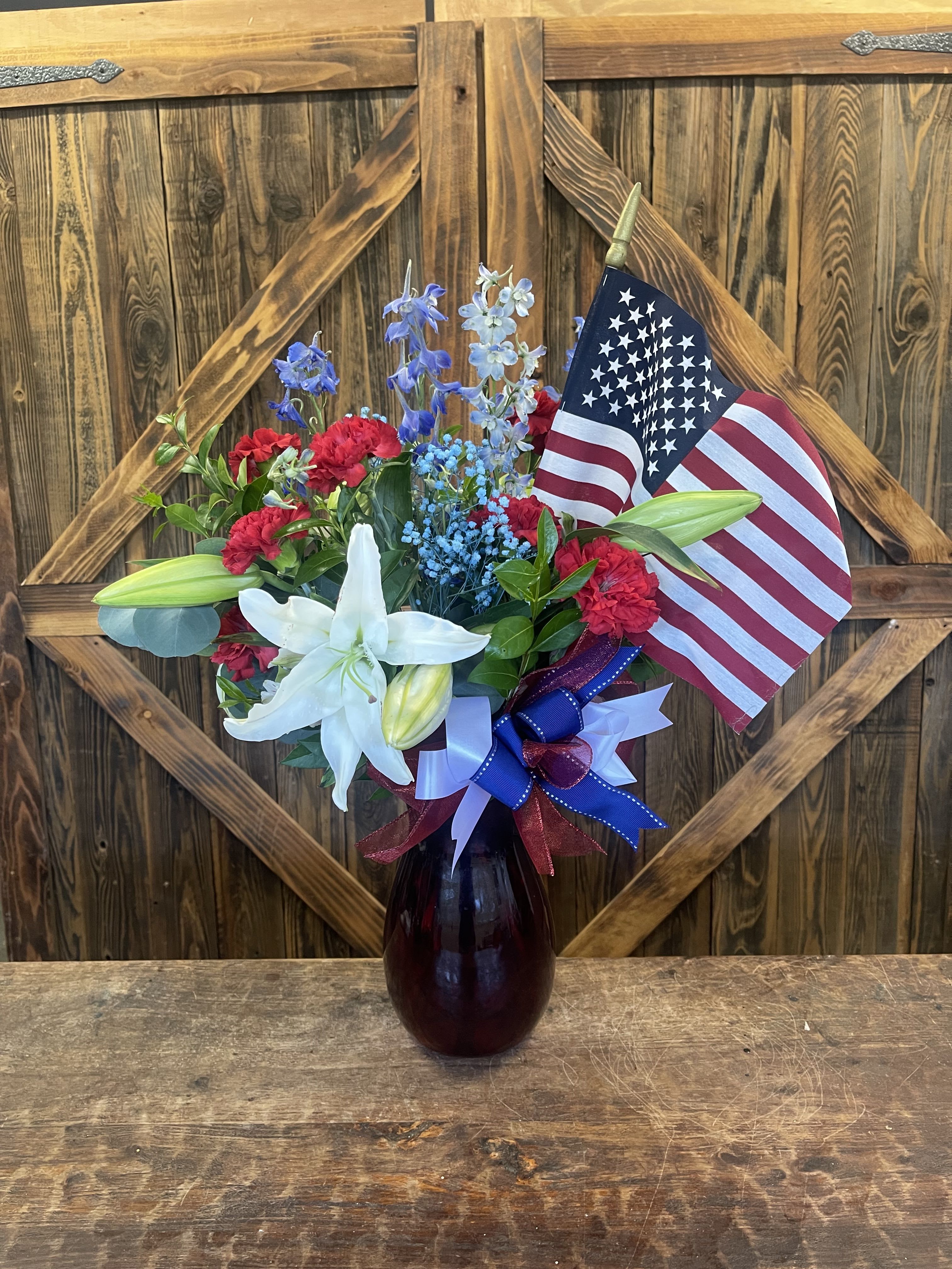 The Patriot - Red, white, and blue arrangement in a vase that is red, white, or blue as well.