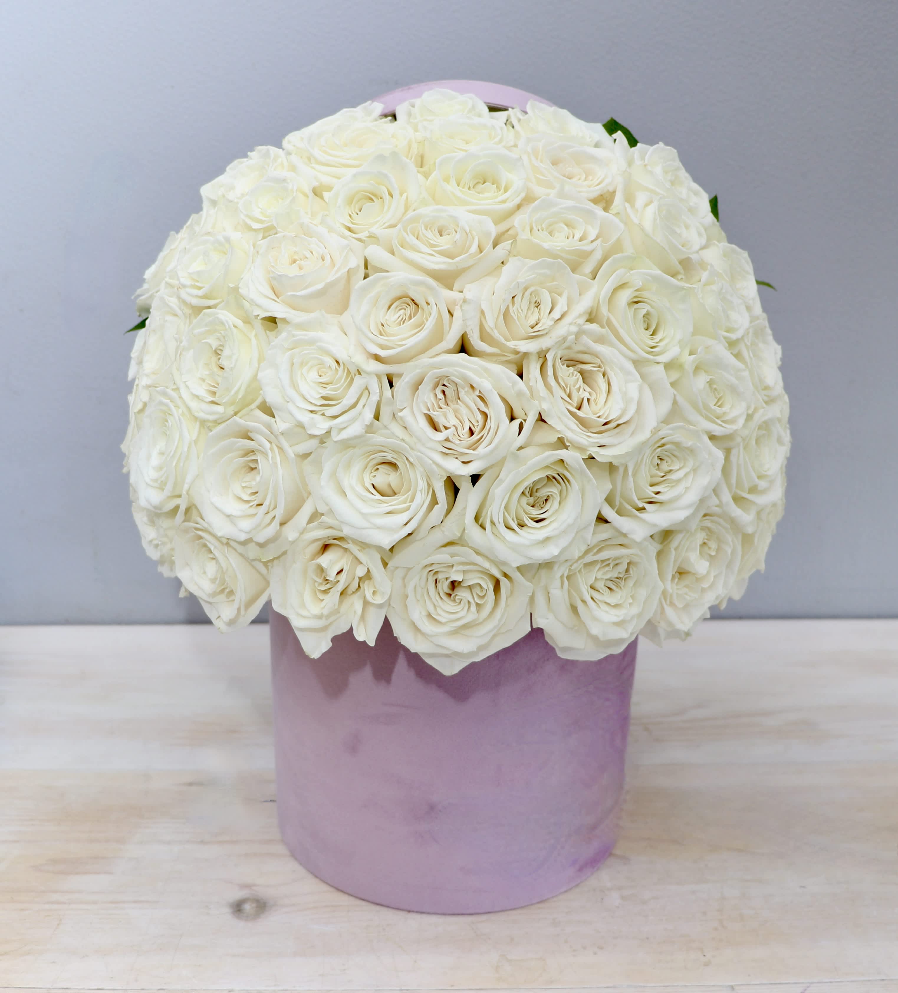 Lavender White Rose HatBox - WeHo - This lavender hatbox is filled with elegant white roses. The standard size holds about 50 roses.