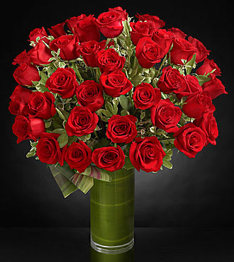 Fate Luxury Rose Bouquet - Fate brought you together for this one incredible moment. Celebrate your love and heartfelt emotion with a display of the most amazing roses. A gorgeous and lush bouquet of 36 premium long-stemmed red roses, beautifully situated in a superior 10-inch clear glass cylindrical vase, are the perfect way to shine a light on your every emotion. 36 premium long-stemmed red roses, assorted greens, exotic foliage and a 10-inch superior clear glass cylinder vase. 