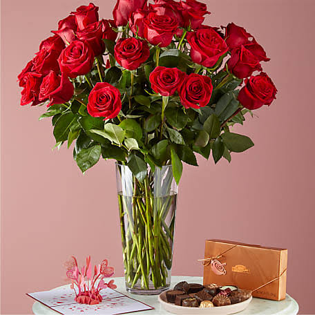 The Legacy Valentines Flowers, Chocolate and Love Pop Card Package - Our combination of 2 dozen roses, chocolates and the Love Explosion Love Pop Card is sure to make this a Valentine's Day to remember.  The arrangement is perfect for all year, but especially for Valentine's Day, Anniversary, Galentine's and any other celebration! Deliver Valentine's Weekend and get our half dozen chocolate covered strawberries for FREE!