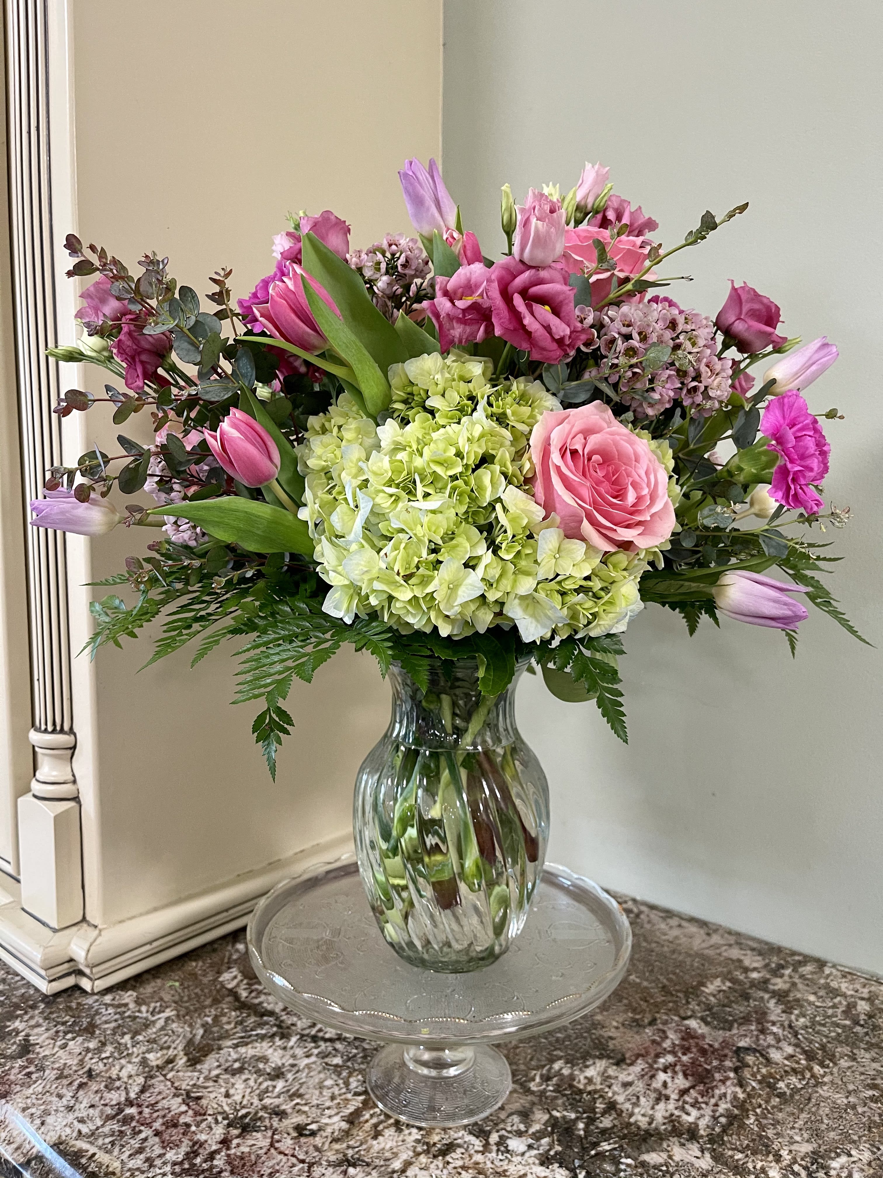 The Spring Blend - The perfect blend of roses, hydrangea, tulips and other designer selected flowers for the perfect arrangement for the Moms in you life.  Approximate Dimensions: 15"D x 15"H