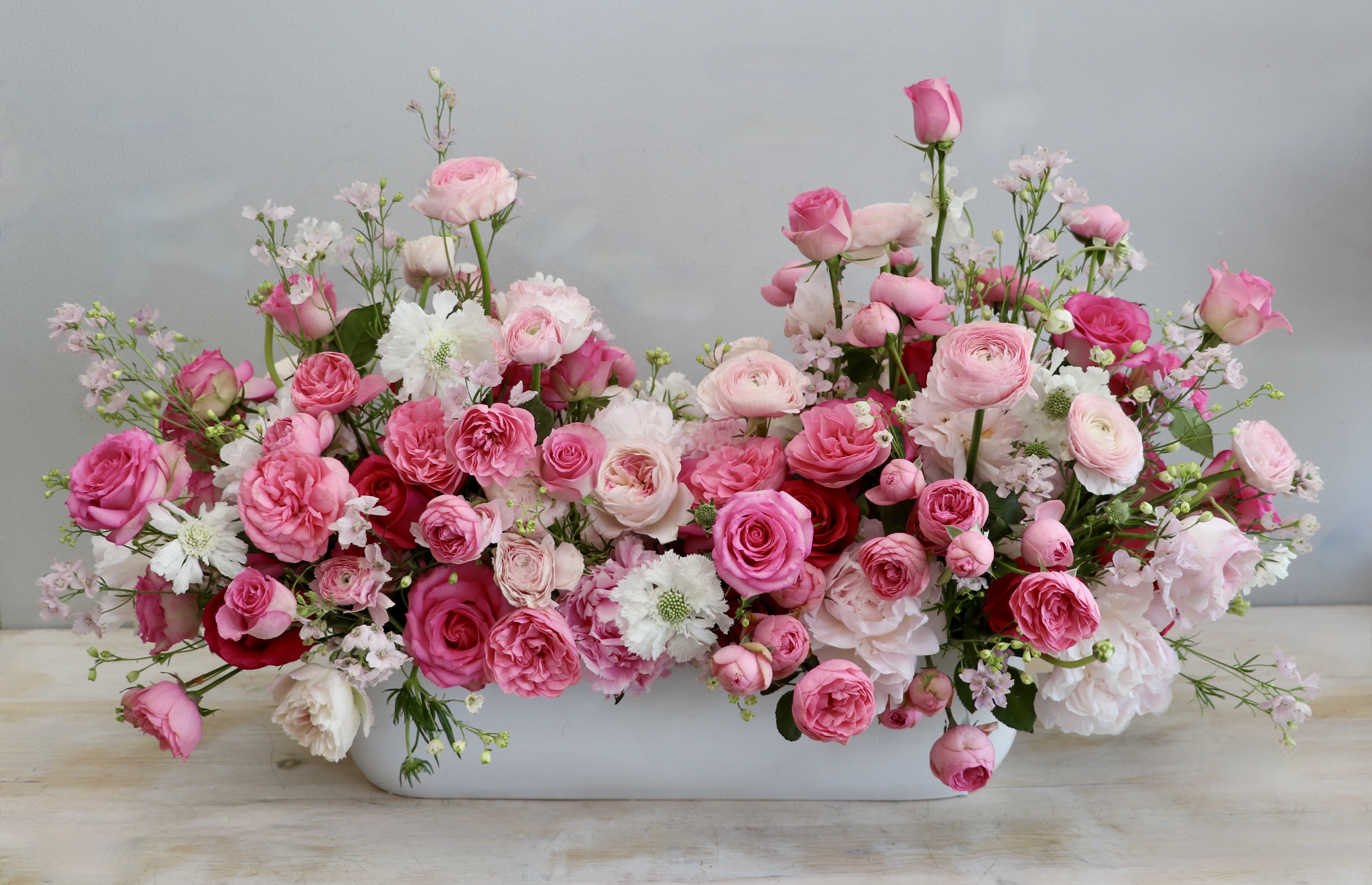 Elysian Garden - Weho  - Wow, wow, wow! This grand masterpiece showcases garden roses, peonies, ranunculus, and seasonal greenery with fillers for a lush arrangement. It's long vase makes for a perfect centerpiece.