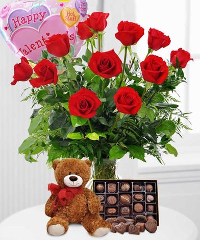 Eckert Florist's Ultimate Valentine Bundle *Local Delivery Only - 1 dozen long stem red roses arranged, 1 plush teddy bear, 1 box of chocolates, and 1 Valentine mylar balloon, the perfect Valentine's Day gift. *Bear, chocolate, and mylar balloon styles/brands will vary.