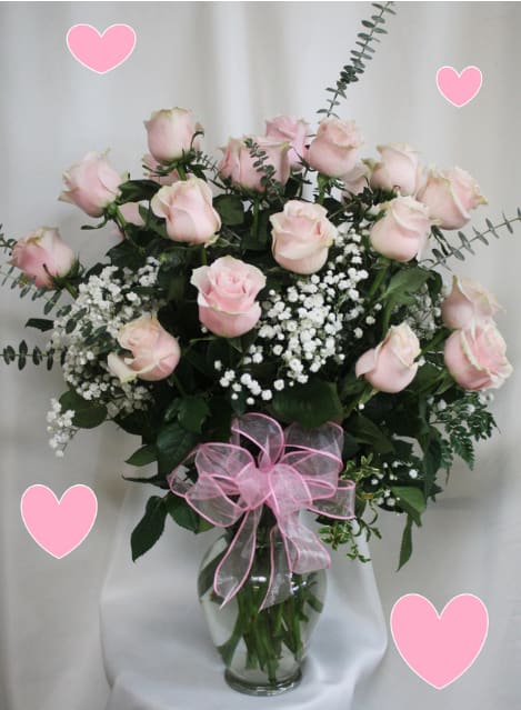 2 Dozen Long Stemmed Light Pink Roses - Two Dozen light pink Roses. This show-stopping bouquet of our lush and romantic pink roses comes complete with baby's breath, greens, and a bow. This vase is hand-arranged by our premier floral designers. 