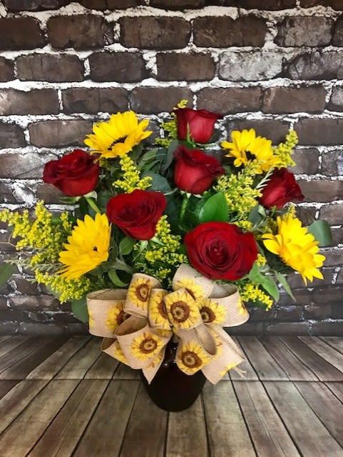 Suns &amp; Roses - A half dozen red roses adorned with 4 sunflowers, filler and greenery.