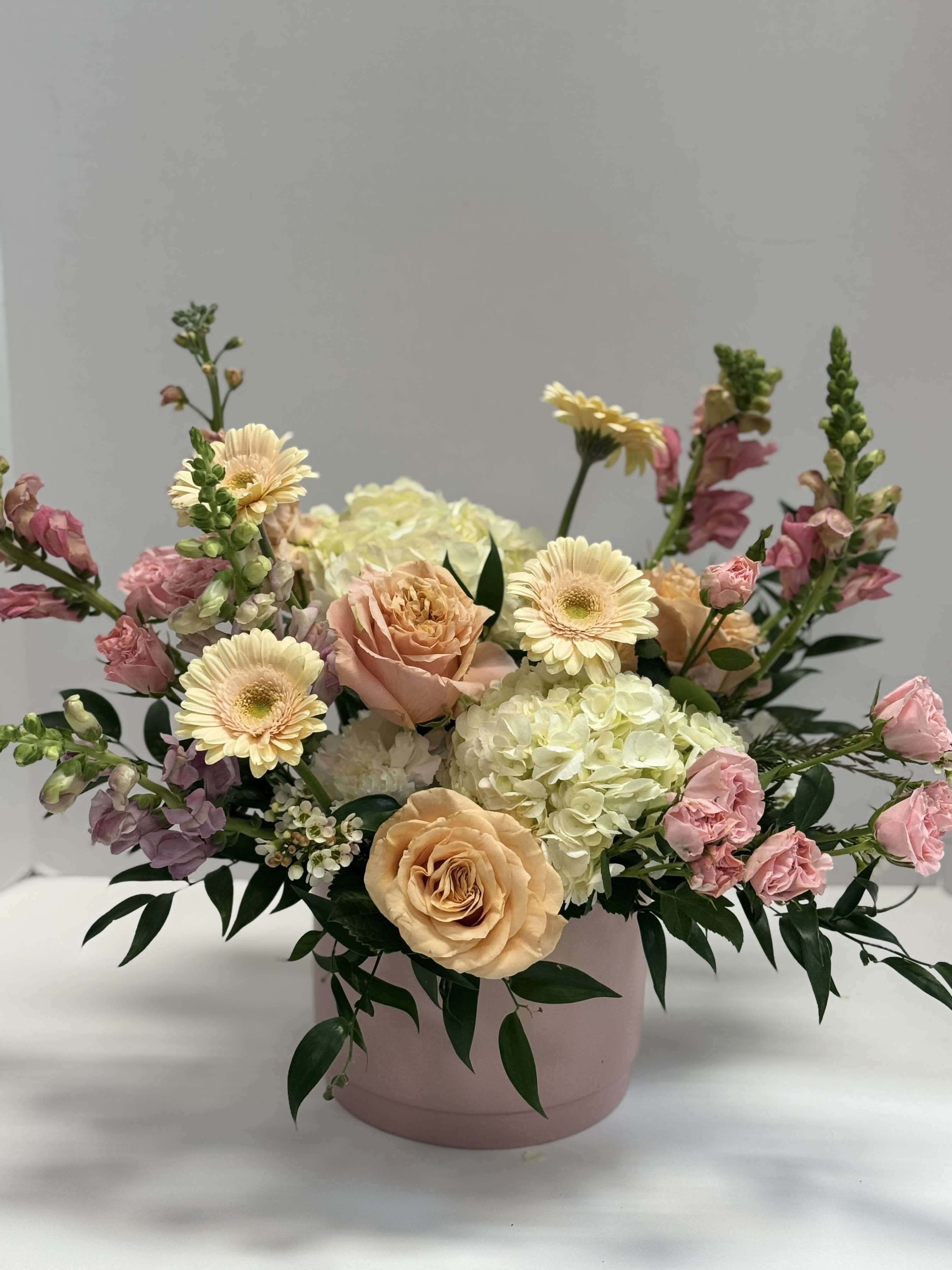 Pastel Valentine - This is one of our favorite color palettes… dreamy pinks and peaches .  We design this in a ceramic vessel that can be refilled later and used again and again… flowers will be seasonal premium blooms that reflect the style and mood.