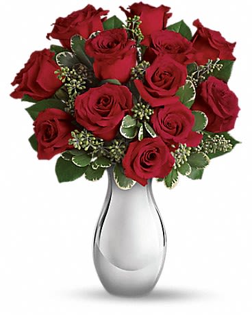 True Romance Bouquet - Turn up the heat on a new romance - or a lifelong love affair - with this classic composition. It features one dozen of our finest red roses arranged in our stunning Silver Reflections vase. This romantic bouquet includes twelve red roses accented with seeded eucalyptus and variegated pittosporum, all delivered in our exclusive Silver Reflections vase, a metalized ceramic vase with a light pink tone. Approximately 12 1/2" W x 16" H