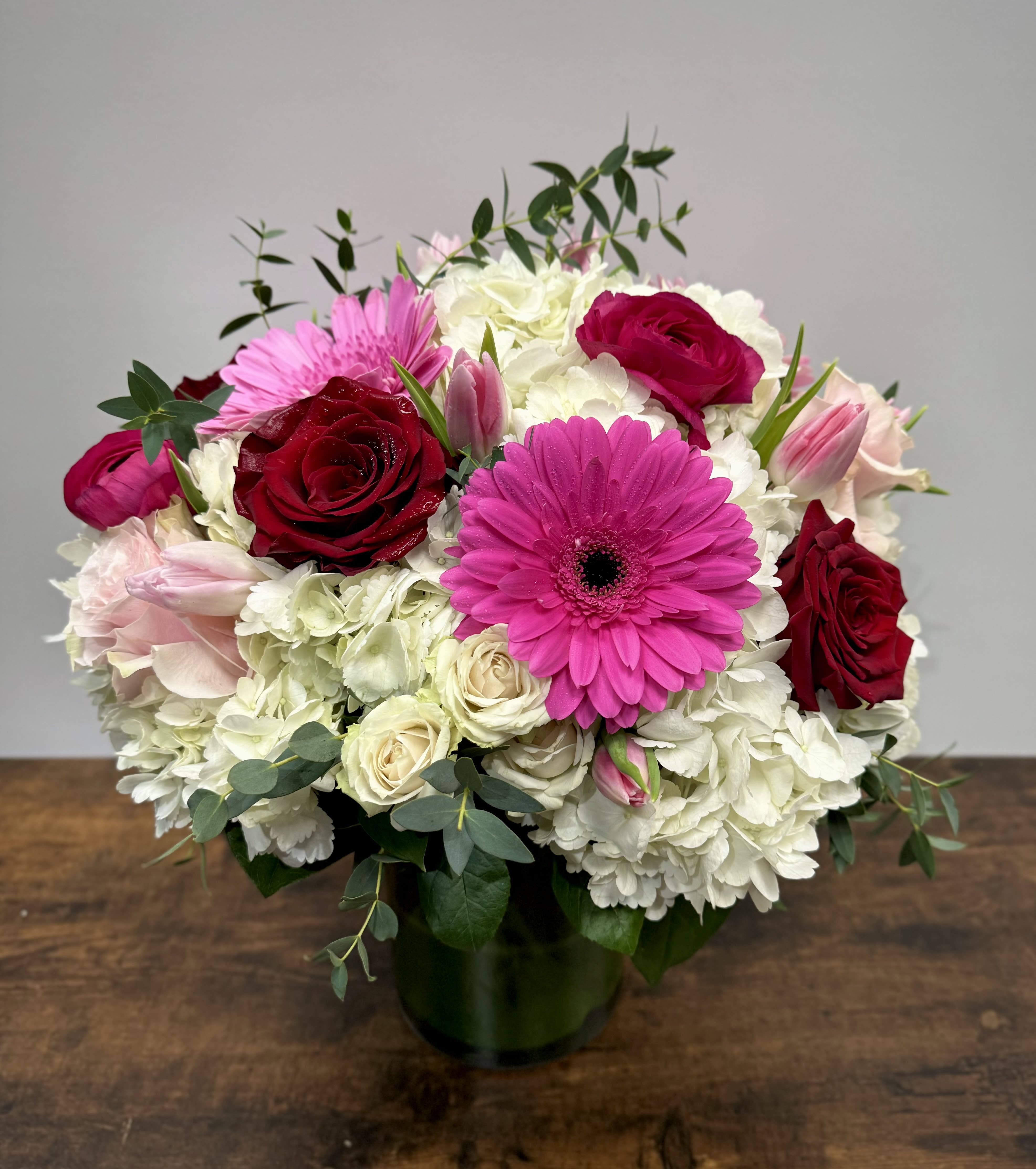 Lovely day - lush mix including hydrangeas, roses, gerber daisies, tulips,  etc