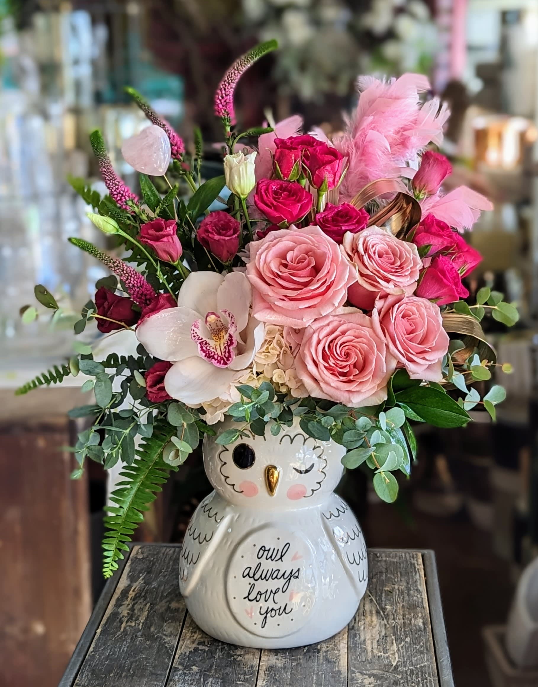 Lovey - Lovey the Owl is a heart-stealing floral arrangement full of whimsy and warmth—perfect for owl lovers, nature enthusiasts, or anyone who enjoys a touch of woodland charm. Nestled in a sweet ceramic owl vase with wide eyes and a gentle expression, this delightful design features soft pink roses, creamy hydrangea and accented with touches of plum lisiantus and textured greenery.  The palette is fresh, playful, and uplifting—like a spring morning in the forest. With its friendly face and flower crown of color, Lovey the Owl makes an unforgettable gift for birthdays, get-well wishes, or just because.  Handcrafted by Windmill Floral Expressions in Las Vegas, this arrangement brings joy, character, and a hoot of happiness wherever it goes.