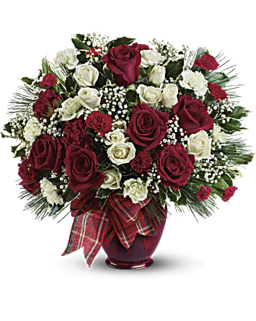 Holiday Splendor - All dressed up in classic Christmas colors, this holiday floral arrangement is delivered in a delightful ruby red vase tied with plaid taffeta ribbon. White pine, holly branches and red and white blooms keep the feeling festive. White roses and red and white carnations are mixed with delicate white million star gypsophila, holly branches and white pine. Presented in a deep red vase with plaid taffeta ribbon bow. Orientation: All-Around  SUBSTITUTION POLICY – Always deliver the freshest flowers! Please note the bouquet pictured reflects our original design.  If the exact flowers or container in this arrangement are not available, our local florists will create a beautiful bouquet with the freshest available flowers.