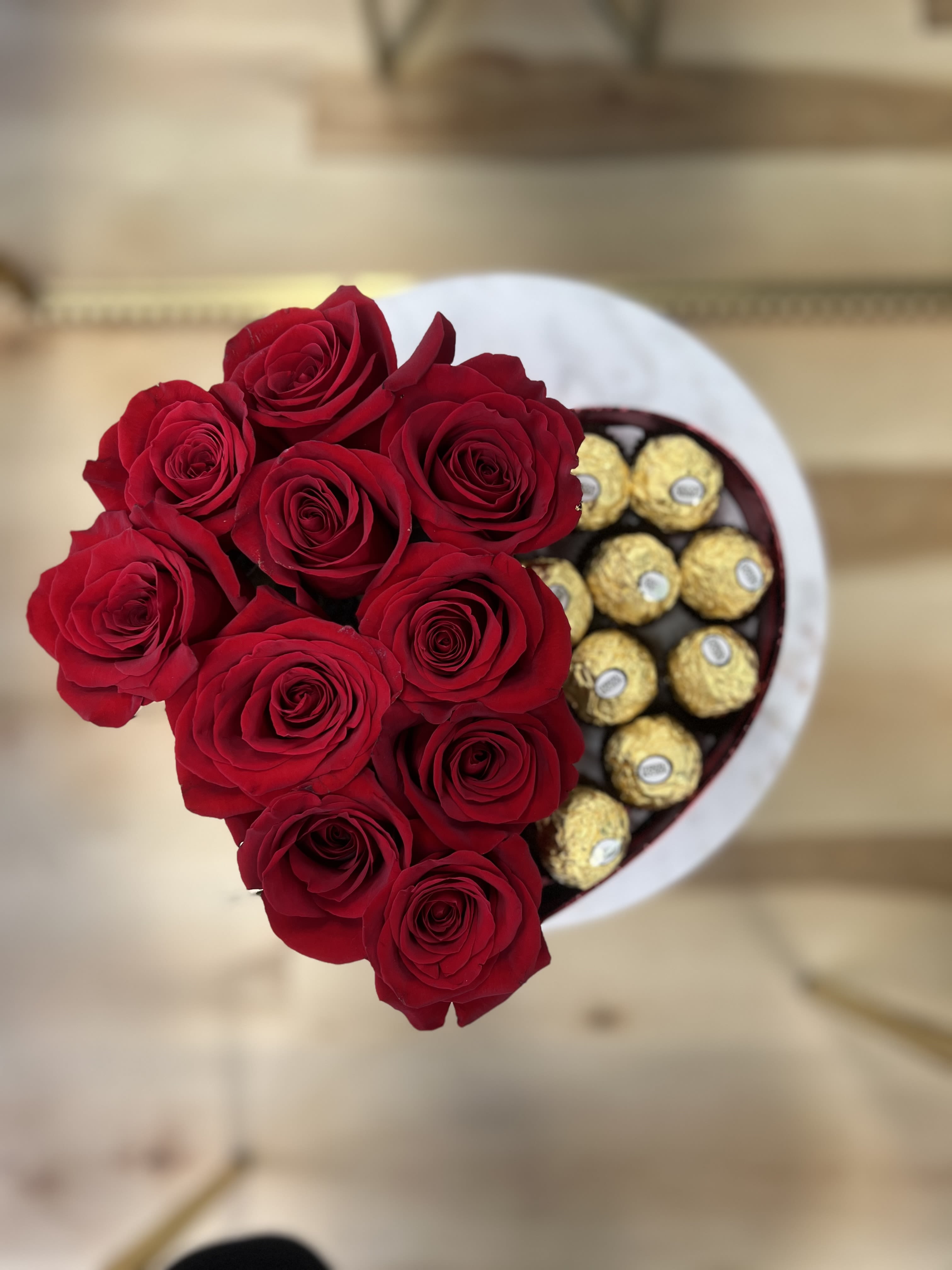 Life’s a box of chocolates  - A dozen red roses and a dozen ferro rocher chocolates arranged in a heart shaped box. 