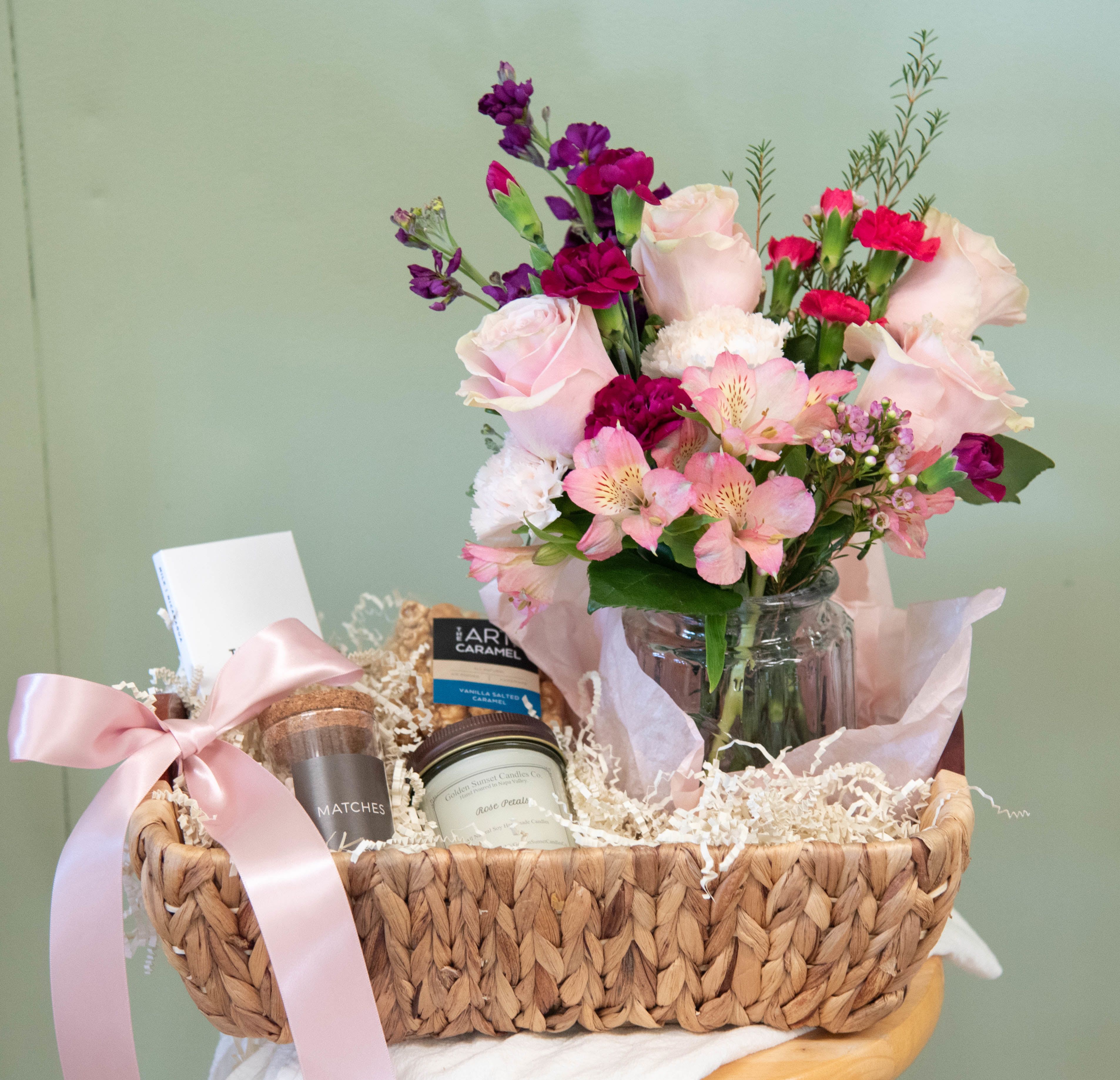 Valentine's Day Pretty-In-Pink Gift Basket- Flower Arrangement - Introducing Pretty In Pink!  Make her Valentine's Day extra special this year!  Handpicked from the finest local artisans. Experience the passion and quality of locally sourced products, delivered straight to your doorstep.  This box includes: Designer's choice flower arrangement  Golden Sunset Candle Co 6oz Rose scented candle K+M Chocolate Bar Art of Carmel 2oz bag Carmel Popcorn  When you purchase an Arden Road Gift Box, you support multiple local Napa businesses, and it's Oh so sweet!   We make gift-giving beautiful, thoughtful, and easy! We make shopping locally even easier!
