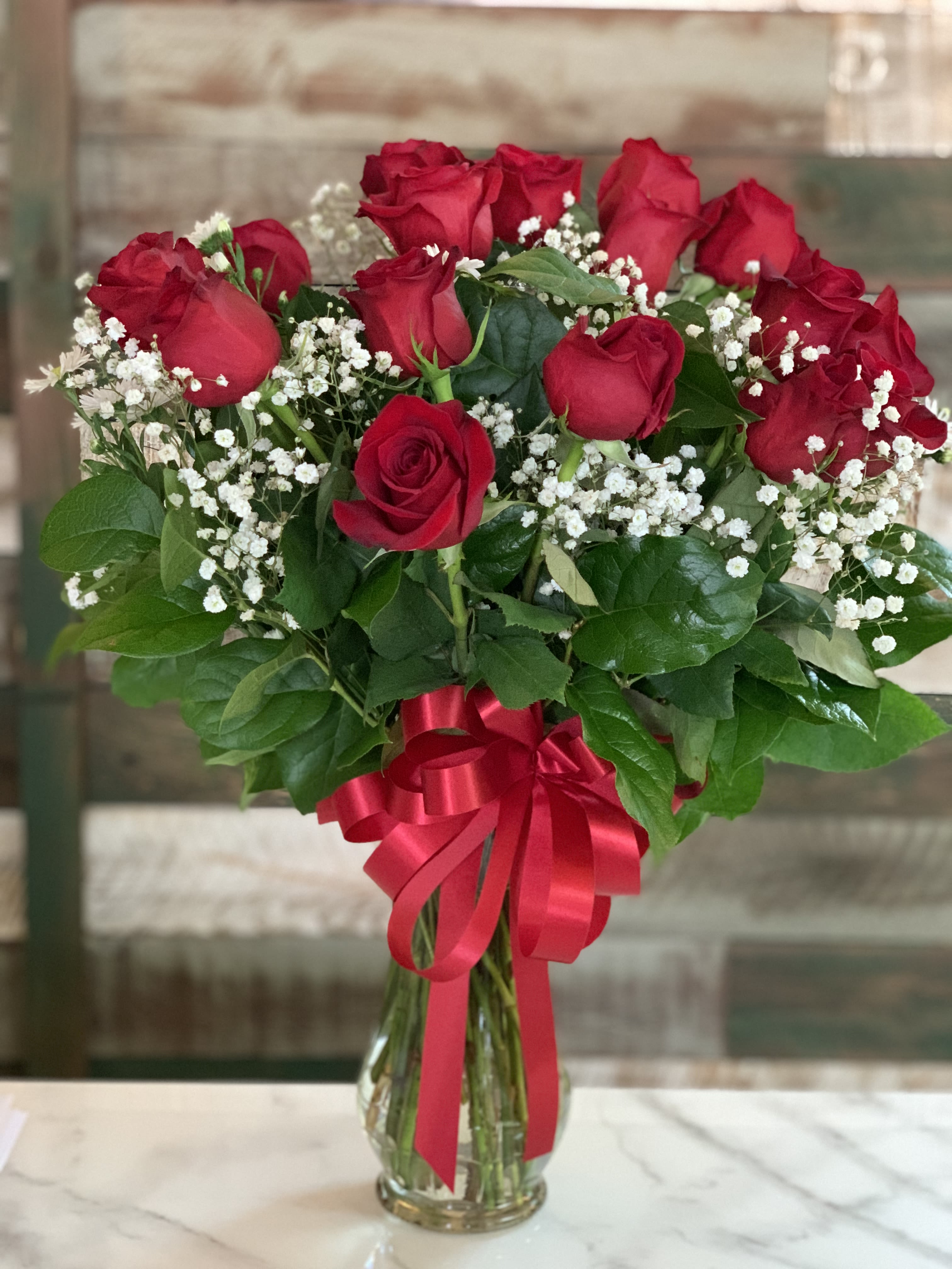 A VDay Bouquet - Red Roses at least 12 or enough to fill the vase with traditional greens and fill!! Perfect gesture to express your love this Valentines Day!