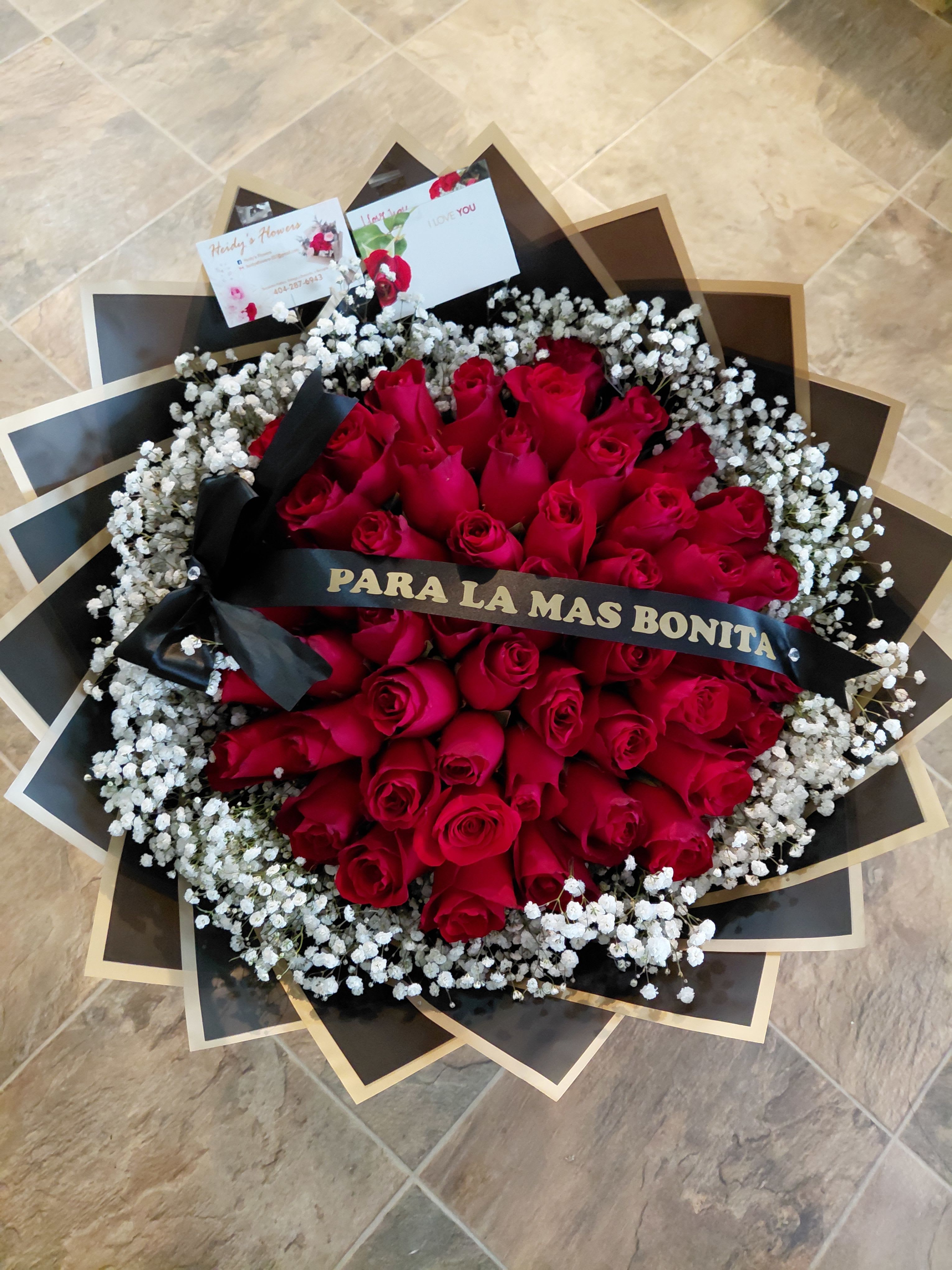 50 red roses - 50 red roses with personalized ribbon and baby's breath wrapped in black paper, with a personalized ribbon.