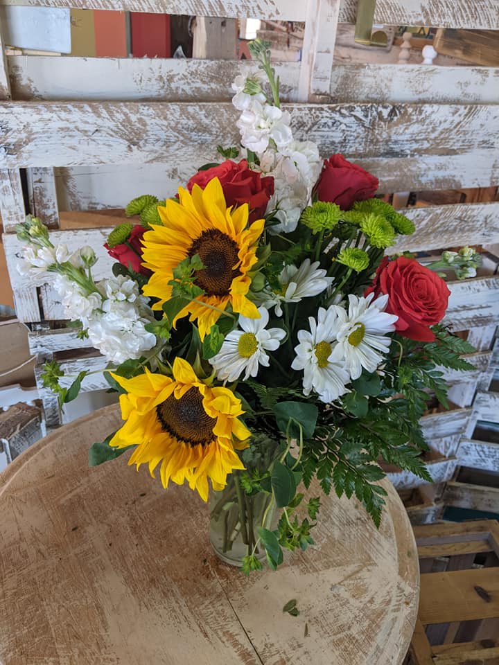 Pure Happiness - Pure happiness is what this pretty bouquet delivers - whether you're sending it for a fall birthday Thanksgiving thank you or simply just because. Surely no one can be in the presence of something so inherently happy and not smile. Sunny sunflowers, roses, stock, daisy spray chrysanthemums, and greens are beautifully arranged in a clear glass vase. 