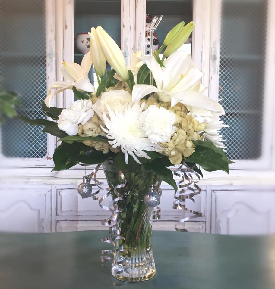 Purest Love  - Sympathy arrangements please call us right away for delivery to Memorials or Funeral Homes. 520-568-4600   This snow-white bouquet. A stunning statement of your purest love this mix of hydrangea and lilies in a Couture vase will take their heart away. This snow-white bouquet includes hydrangea asiatic lilies alstroemeria miniature carnations stock and fresh green pittosporum. Delivered in a glass vase.