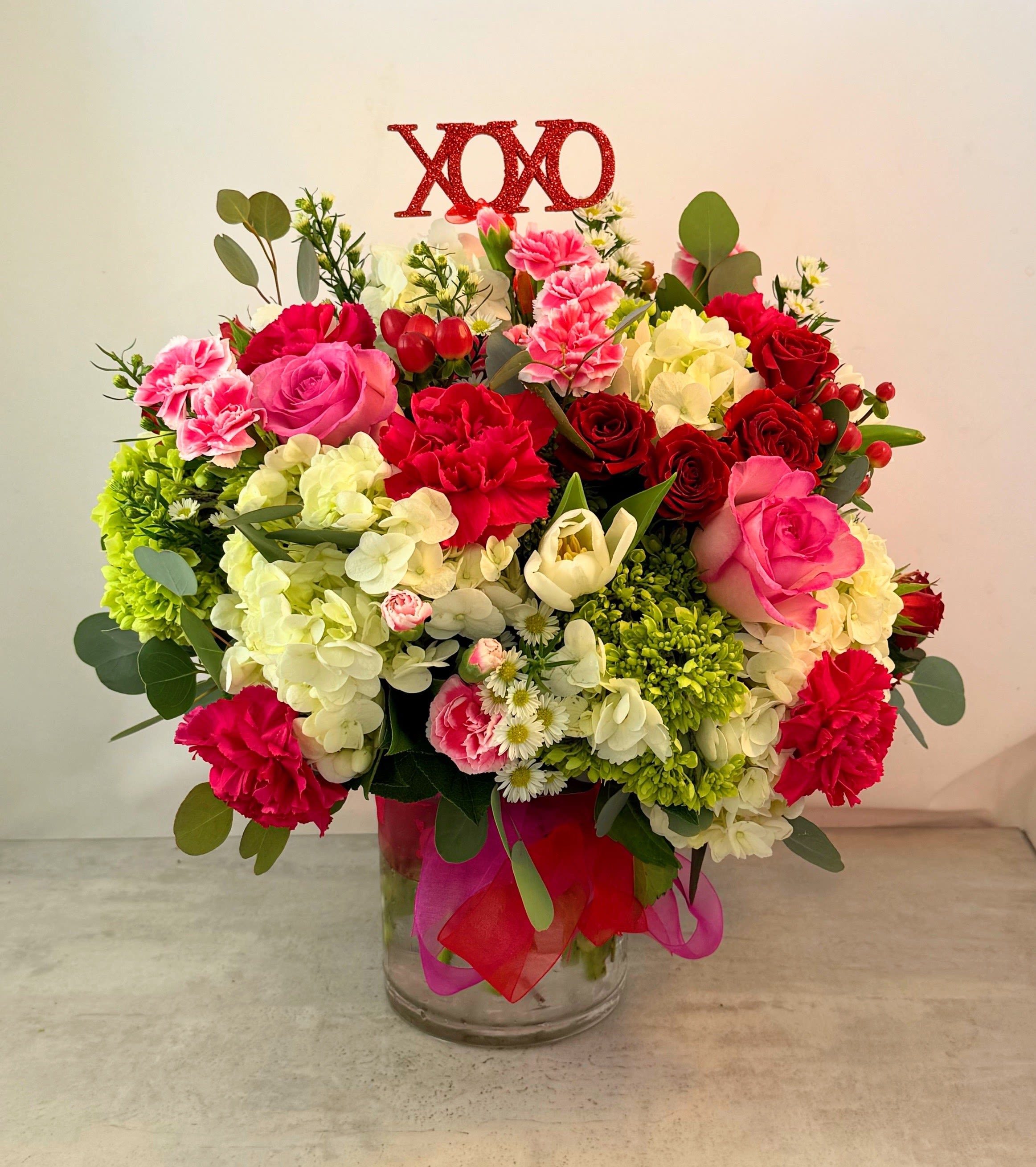 Hugs &amp; Kisses Bouquet - Lets get right to the point! Results matter! If it's hugs and kisses you are after, this bouquet will make it happen. Red and pink roses with huydrangea, eucalyptus and more will let your loved one know just how special they are.