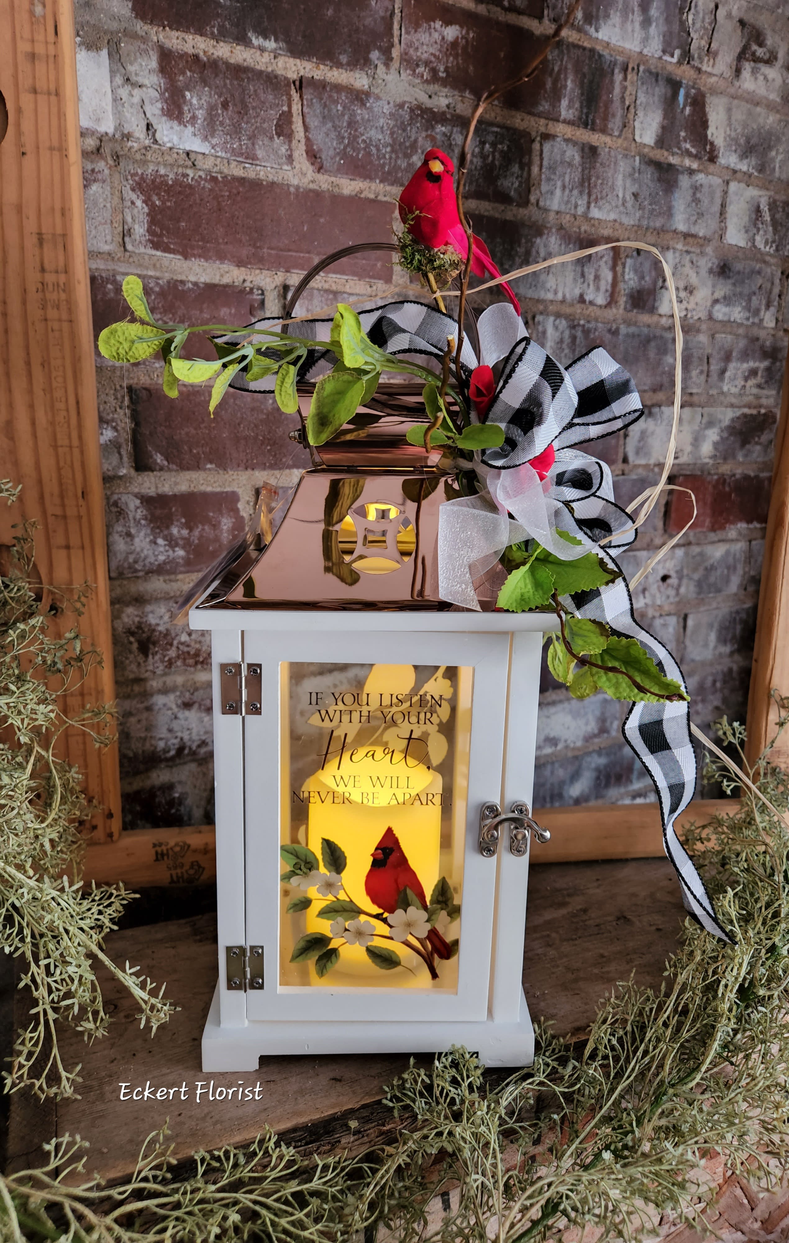 Eckert Florist's "Listen With Your Heart.." Cardinal Lantern - Nice keepsake white wooden lantern with Copper tin roof and sentiment on Dogwood flower and Cardinal bird motif glass. Sentiment: "If you listen with your Heart, We will never be apart" Included is a battery operated candle. Measures approx. 6.25" Square x 15" High *OUR LOCAL DELIVERY ONLY