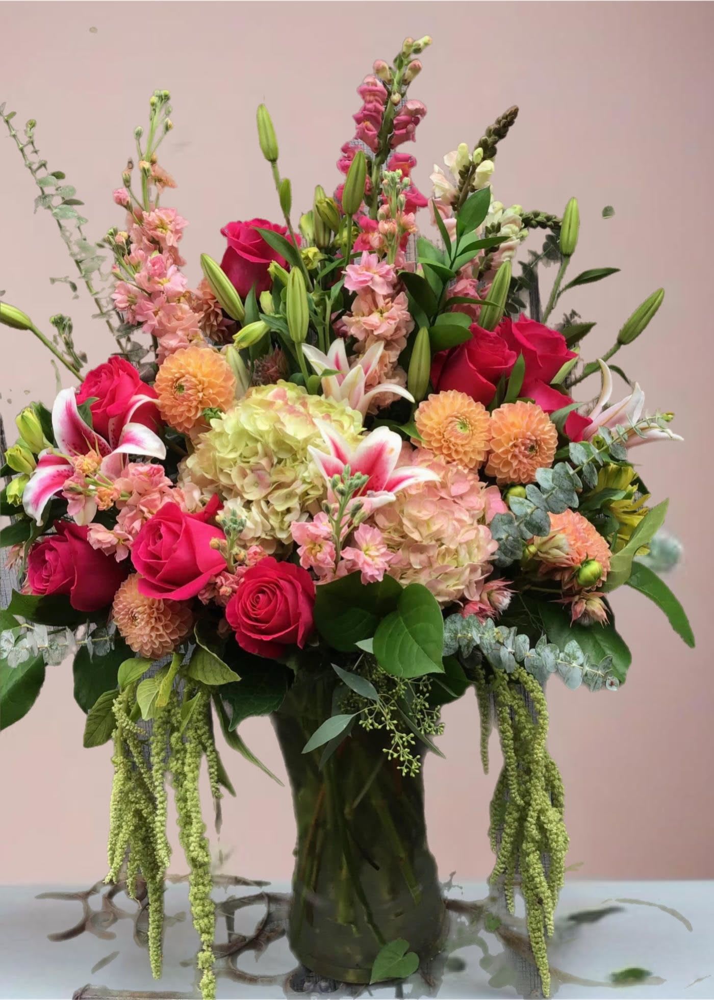 Living Lavishly  - Indulge in floral couture… send the season's most fashionable bouquet! An elegant mix of flowers in a range of pinks, oranges and greens delivered in a clear cylinder vase. A truly fabulous design.