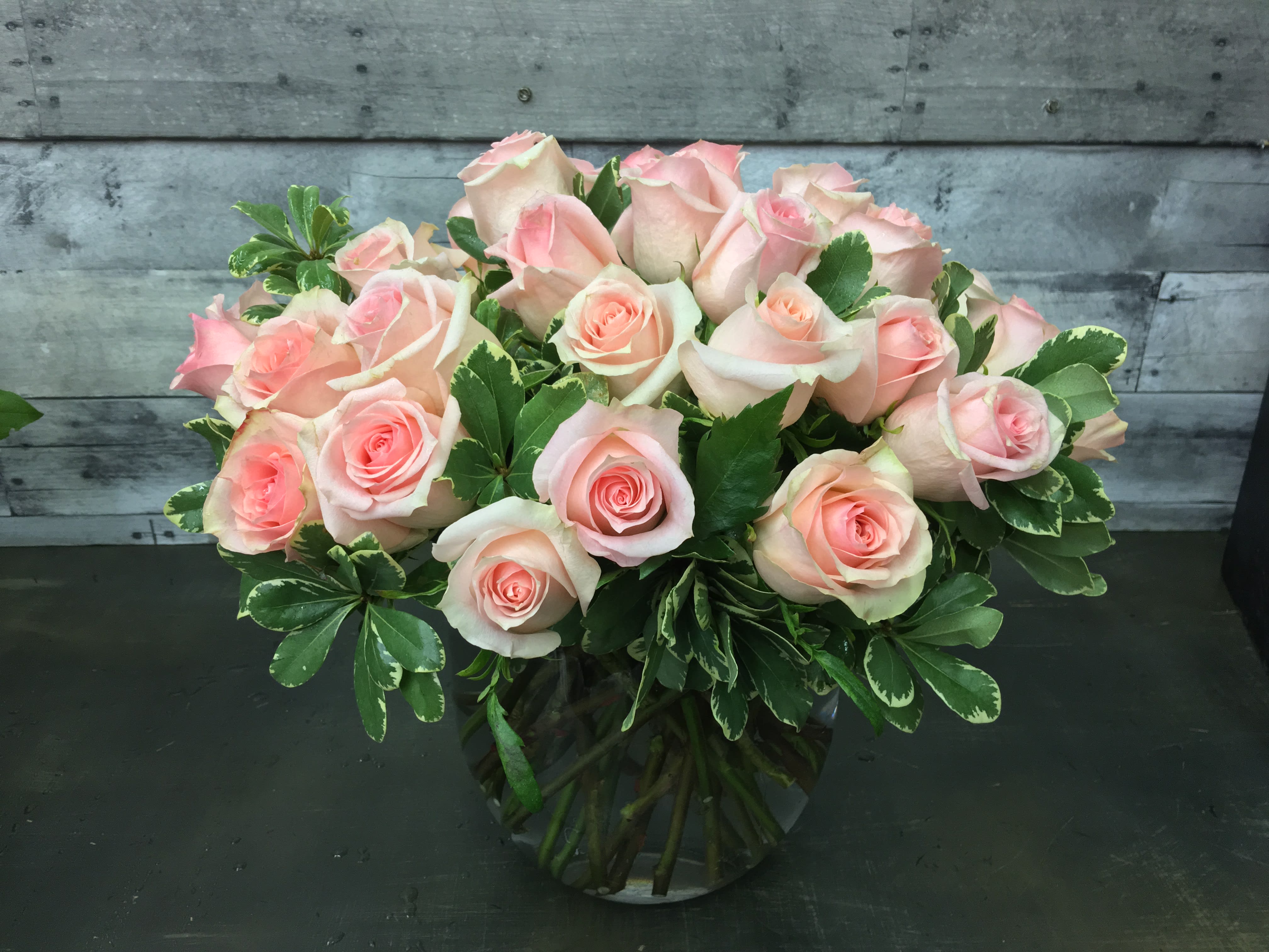 Sweet Rose Bowl - Two dozen roses with lush greens in a bowl vase. For specific color choice please mention - Red, Pink, Hot Pink, Yellow, White or Peach. 