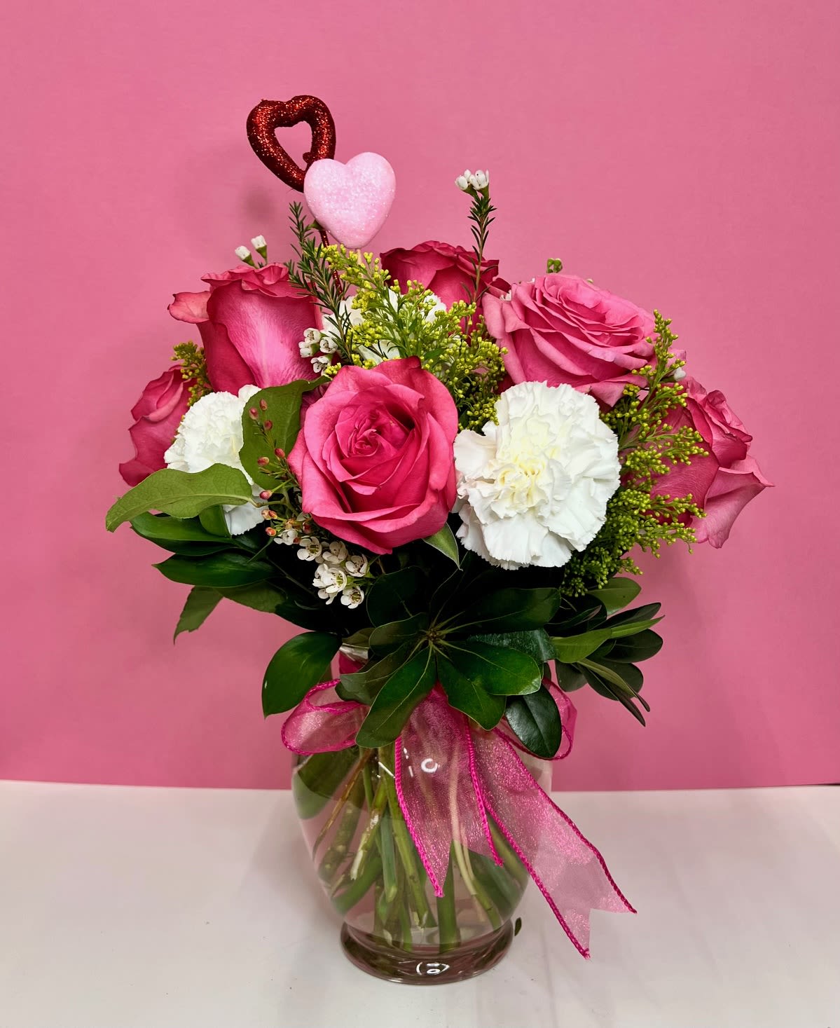 XOXO - This adorable hot pink and white arrangement is perfect for that special someone.
