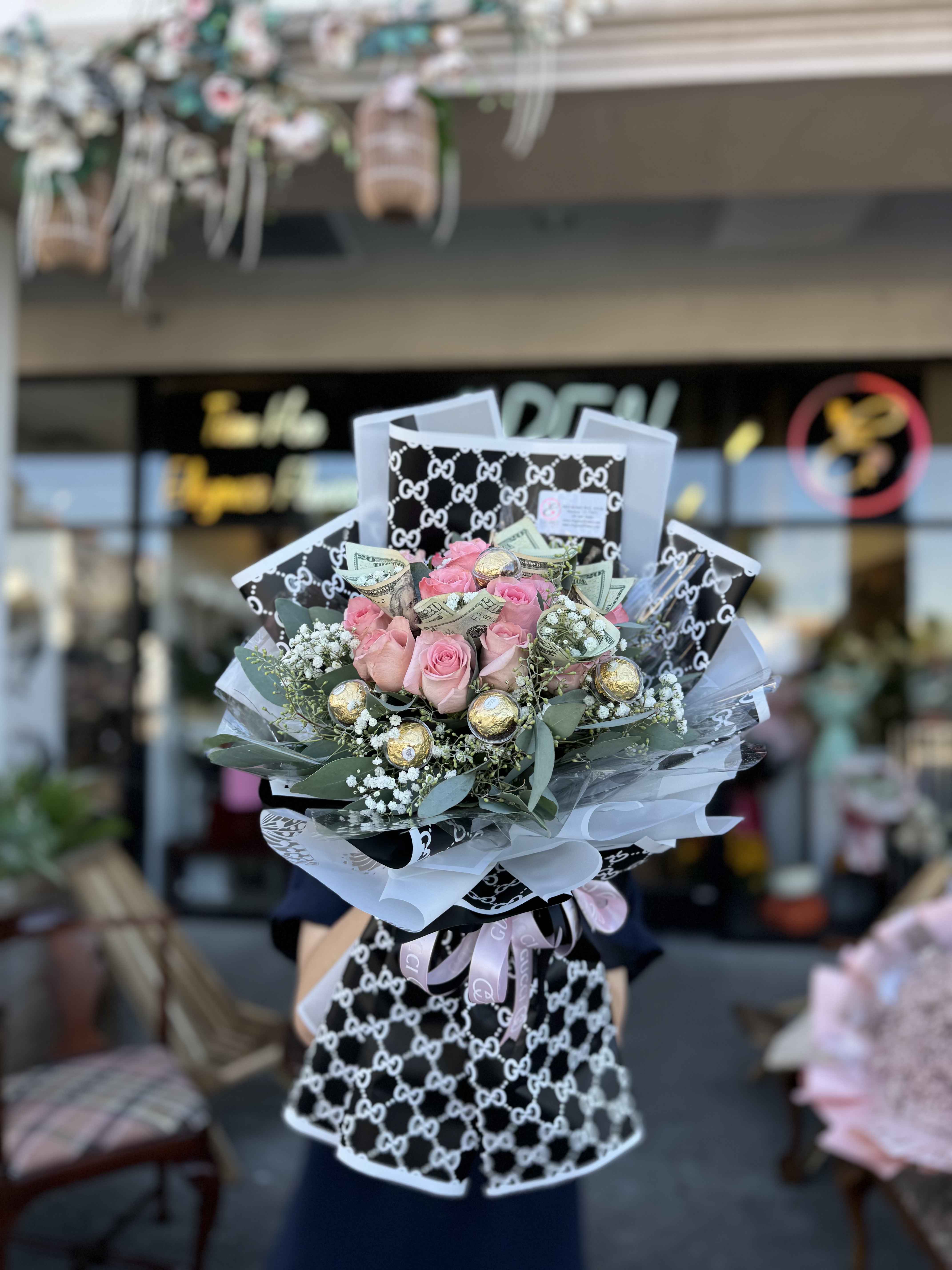 Money Bouquet #4 - Includes $20 x 5 ($100) call for more information 281-564-2600 A wrapped bouquet of flowers is a beautifully arranged collection of blooms, carefully selected and elegantly wrapped in decorative paper or fabric. Wrapped bouquets are perfect for any occasion, from expressing love and gratitude to celebrating special moments, offering a thoughtful and visually stunning gift.