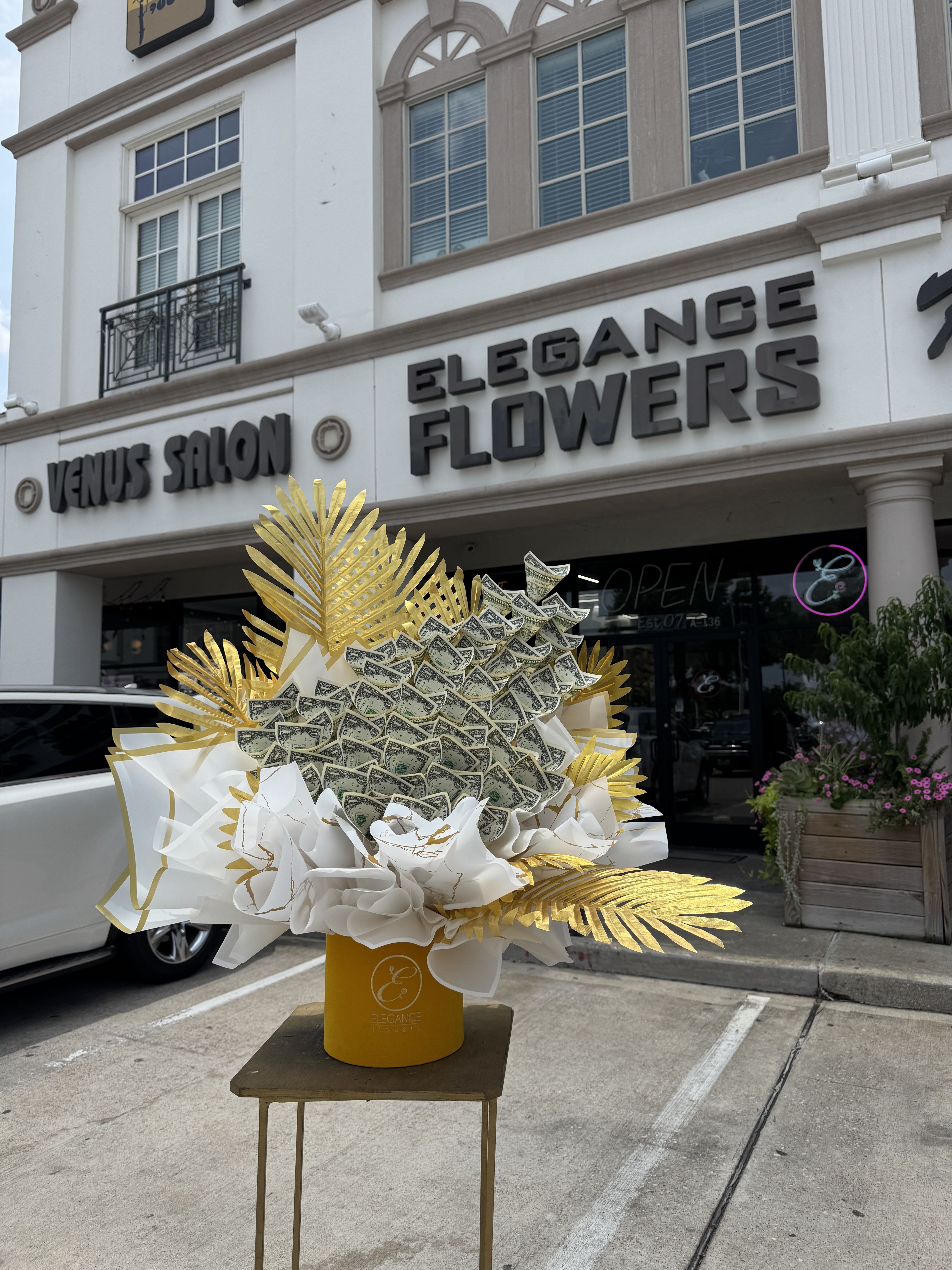 Money Box #2  - Includes $1x 50 ($50), call for more information at 281-564-2600. Money bouquets are unique arrangements featuring dollar bills. They make a creative and luxurious gift for special occasions like birthdays, anniversary, or graduations, combining elegance with practicality.