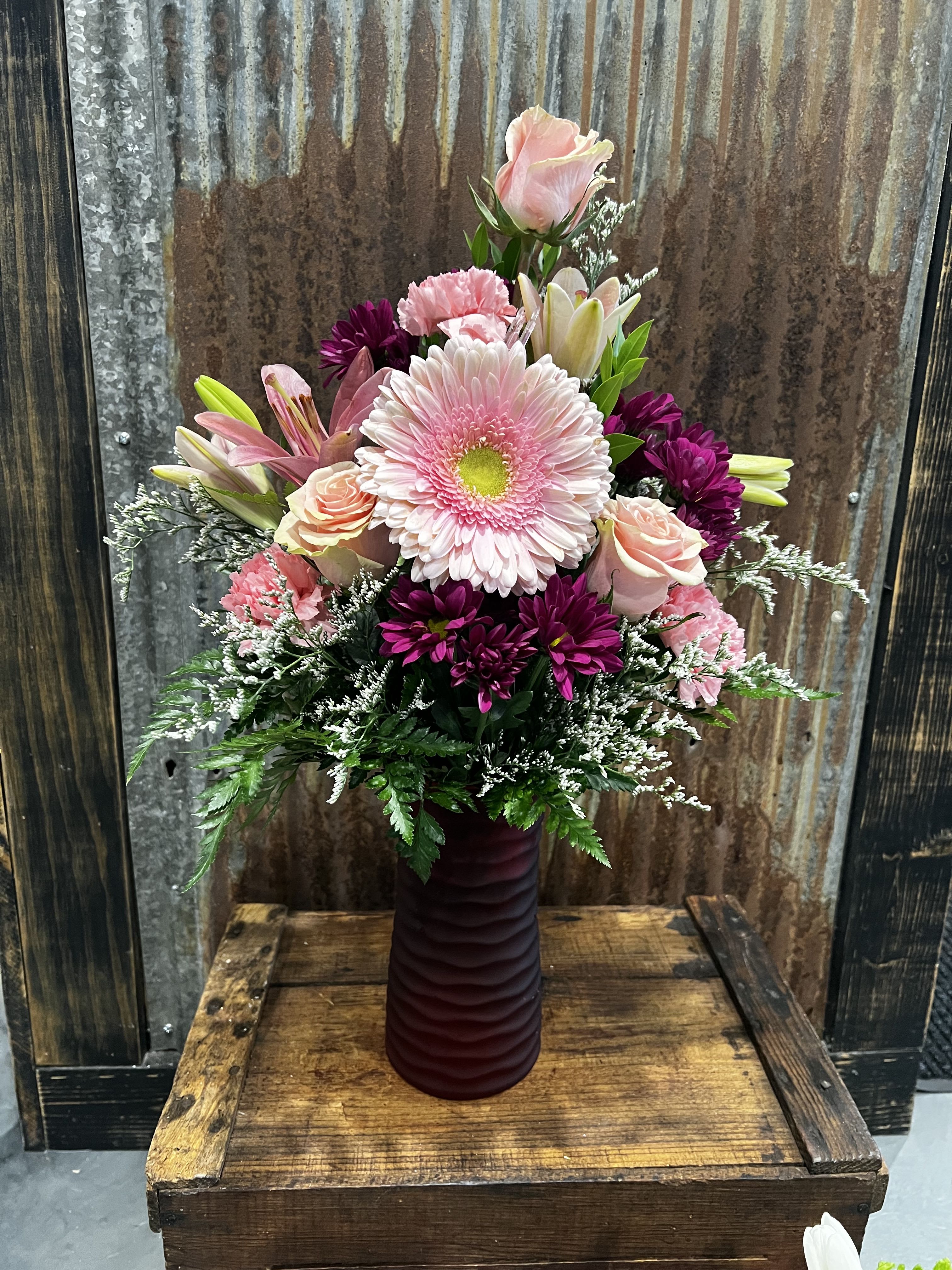 Blushing Berry Bliss  - This bouquet is a soft yet vibrant mix of blush pinks and deep berry tones, artfully arranged in a tall burgundy vase